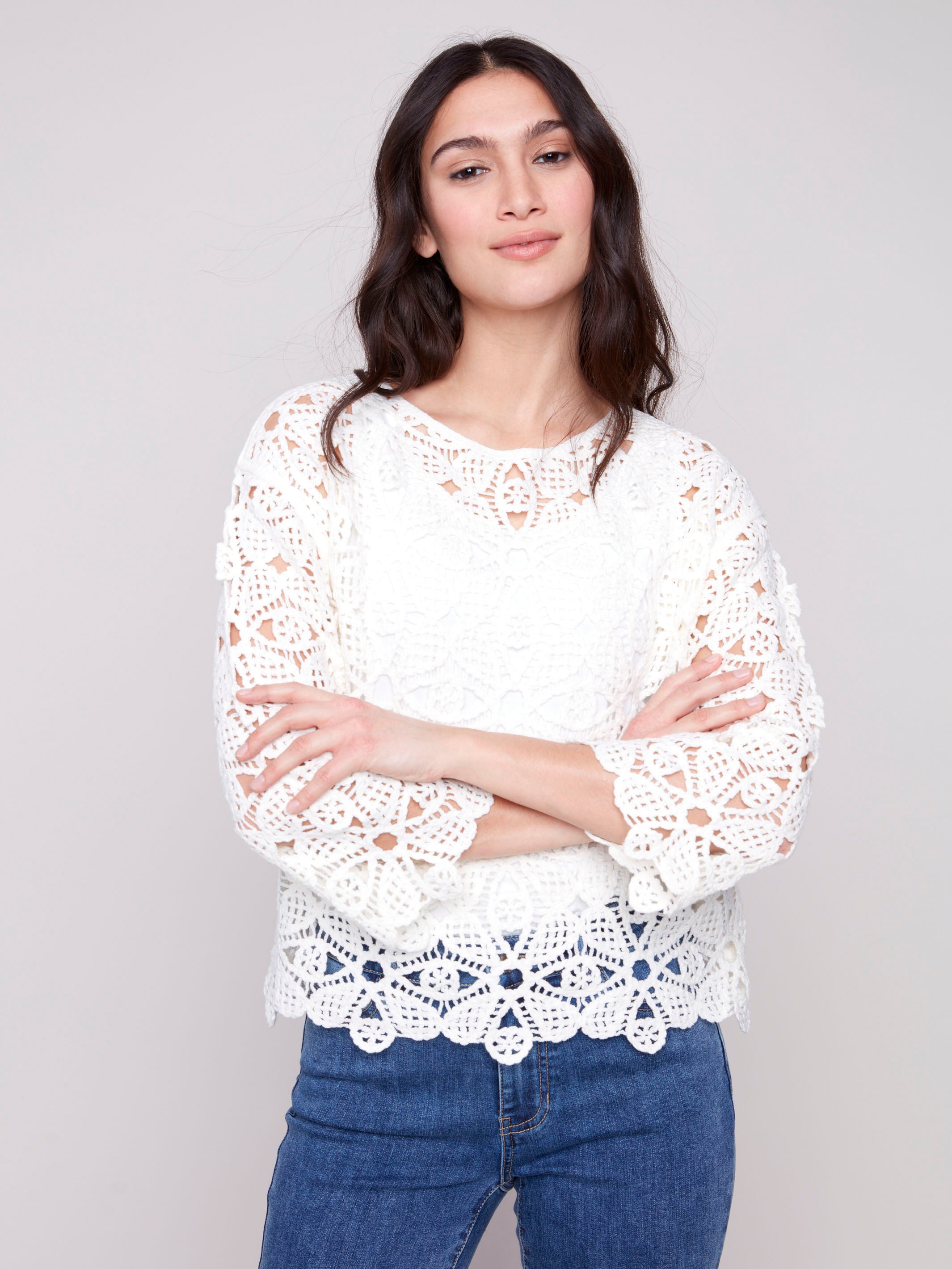 Natural-colored crochet top with a boatneck design by Charlie B.