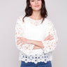 Natural-colored crochet top with a boatneck design by Charlie B.