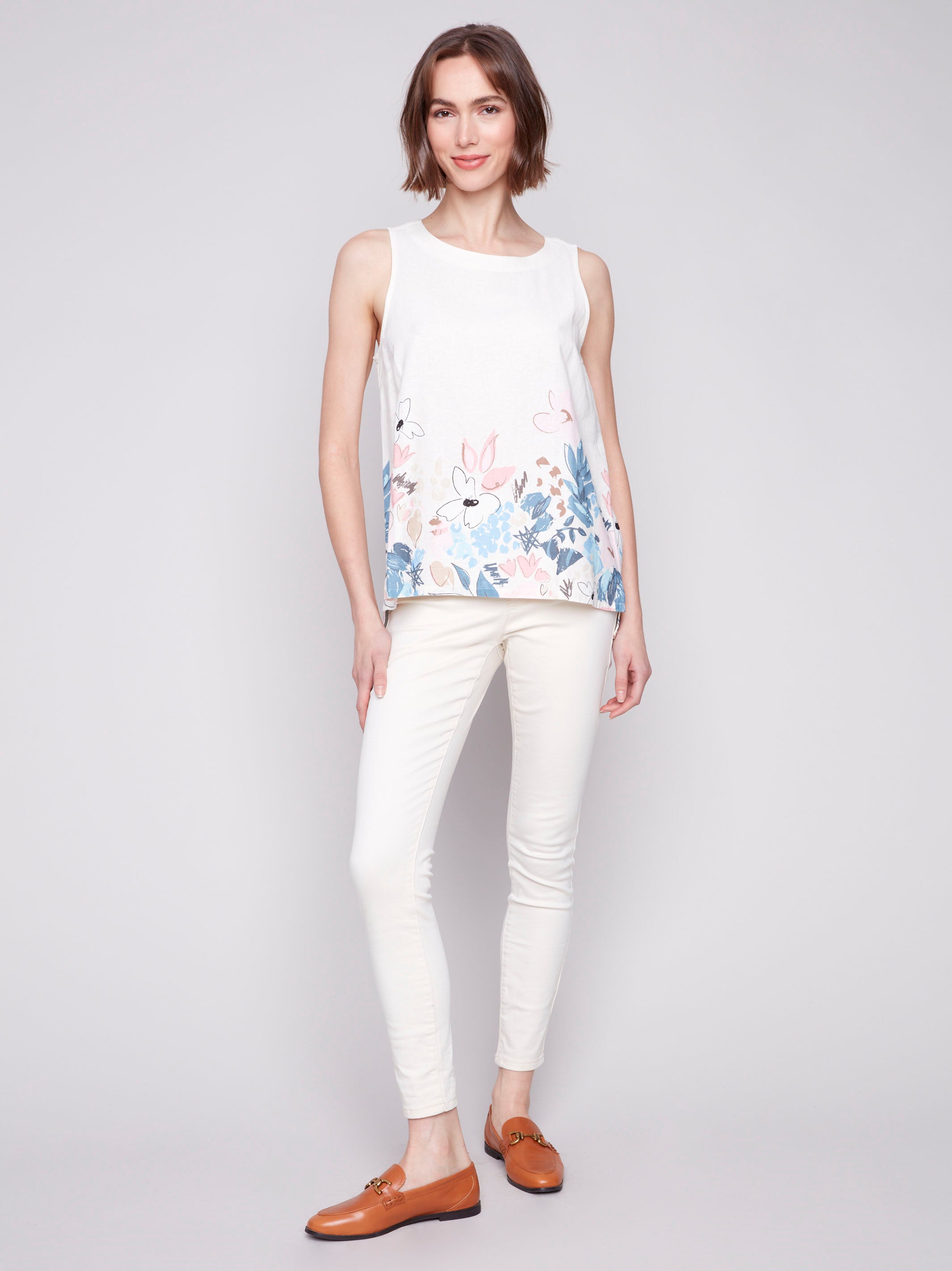 Floral border print sleeveless top with a high-low hem by Charlie B.