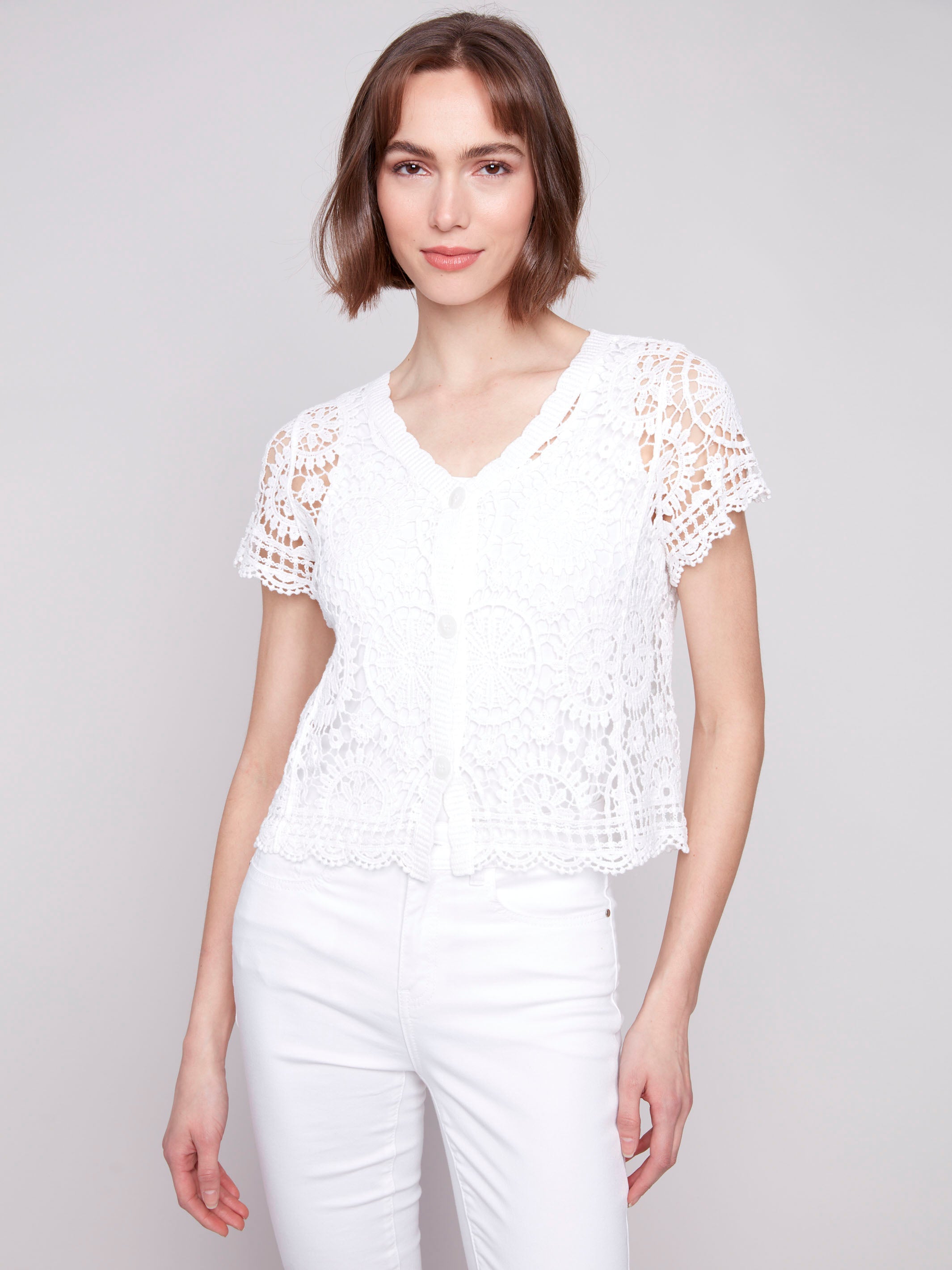 White crochet bolero cardigan with V-neck design by Charlie B.