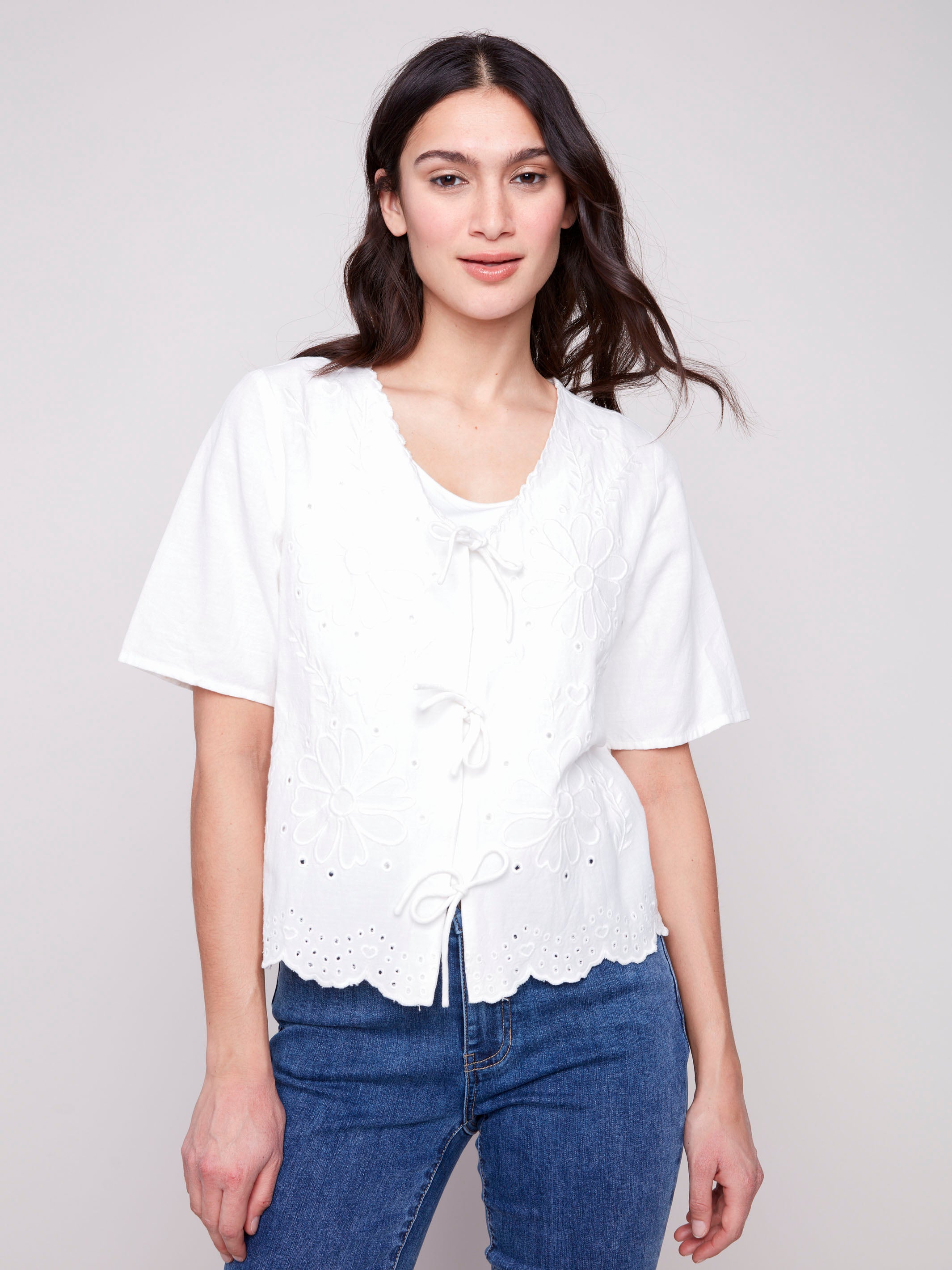 White blouse with scalloped hem and eyelet detailing by Charlie B.