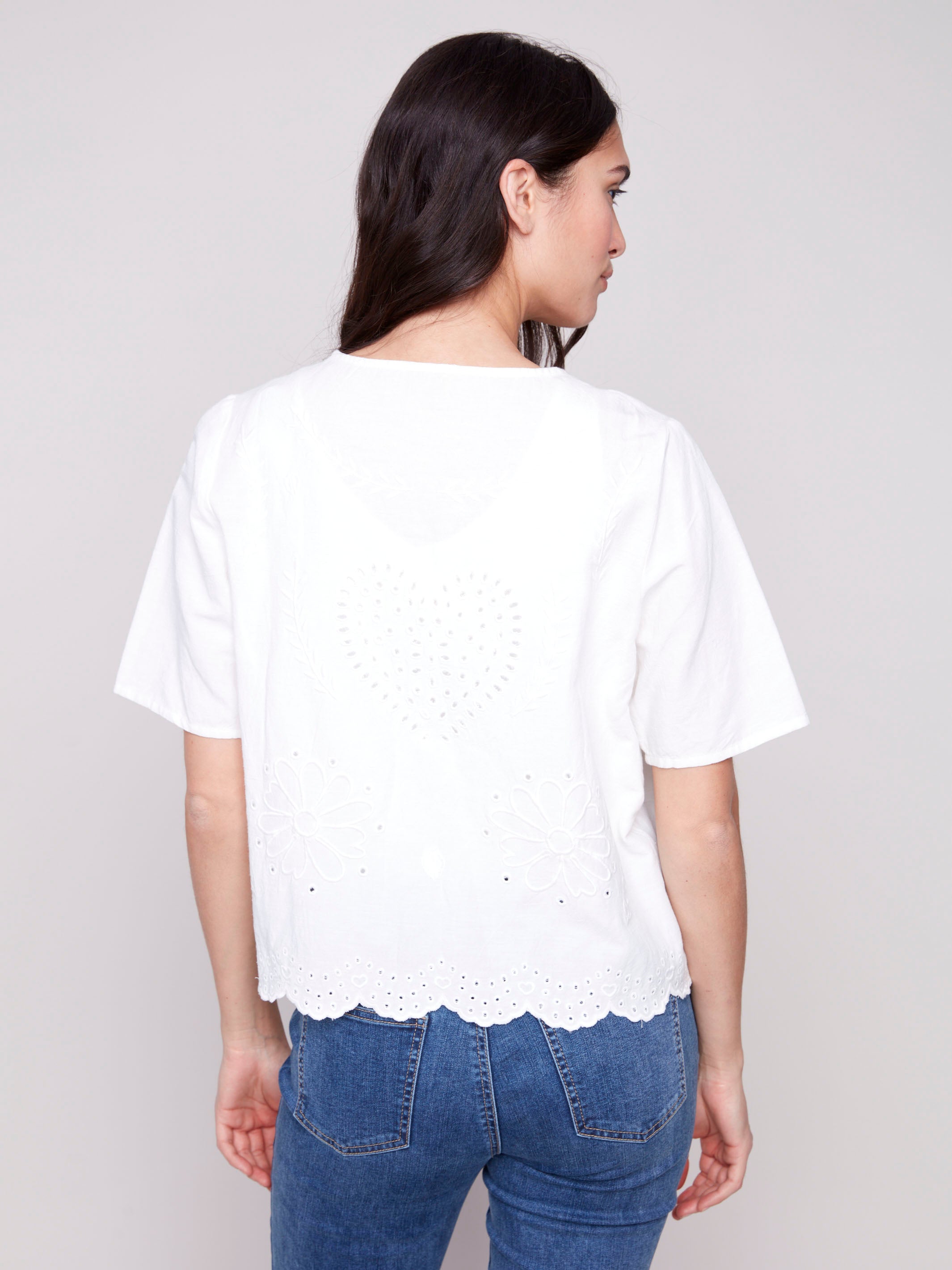 Elegant V-neck blouse with detailed eyelet work by Charlie B.