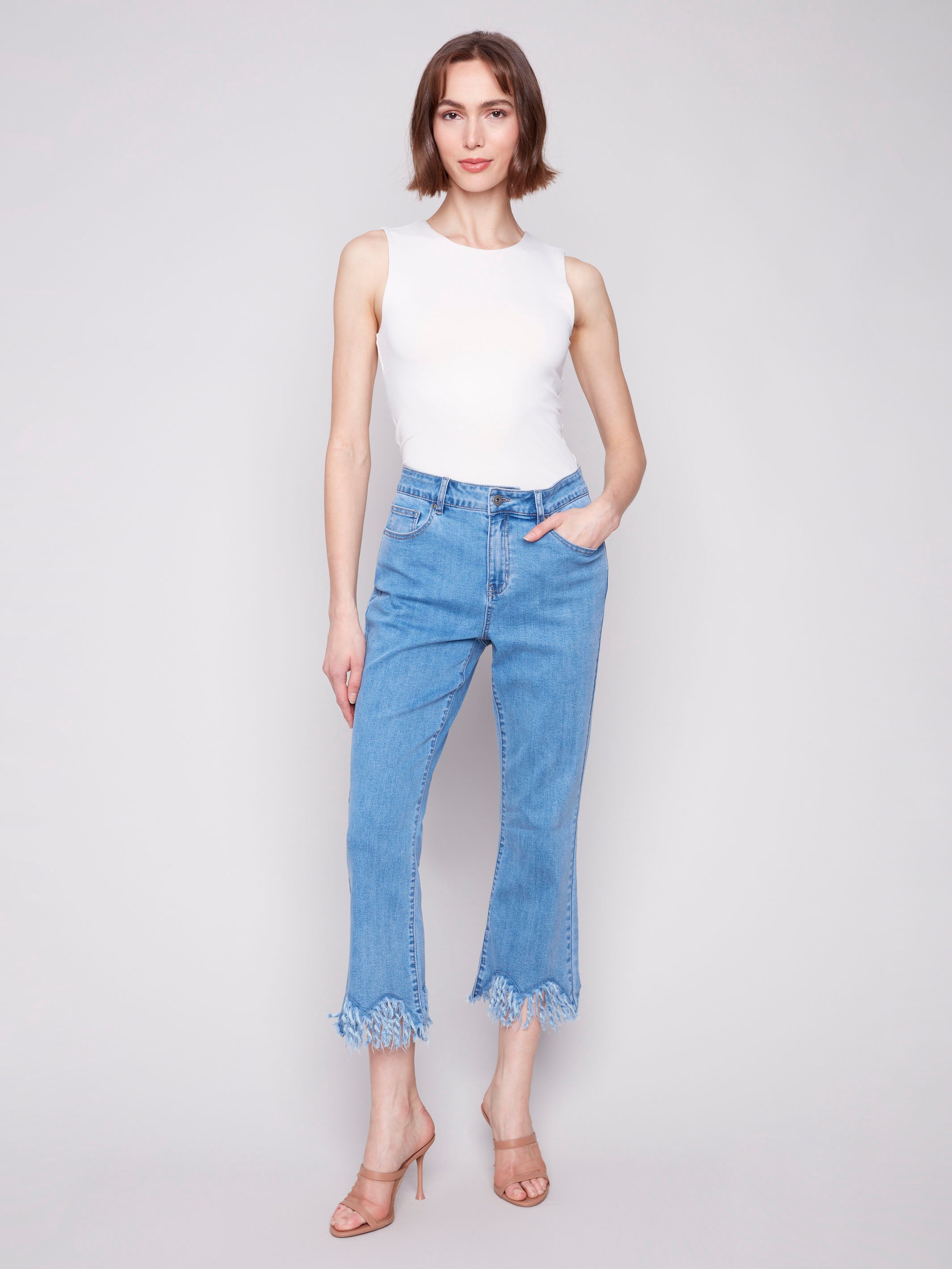 Blue cropped jeans with a fashionable fringed hem and bootcut leg design by Charlie B.