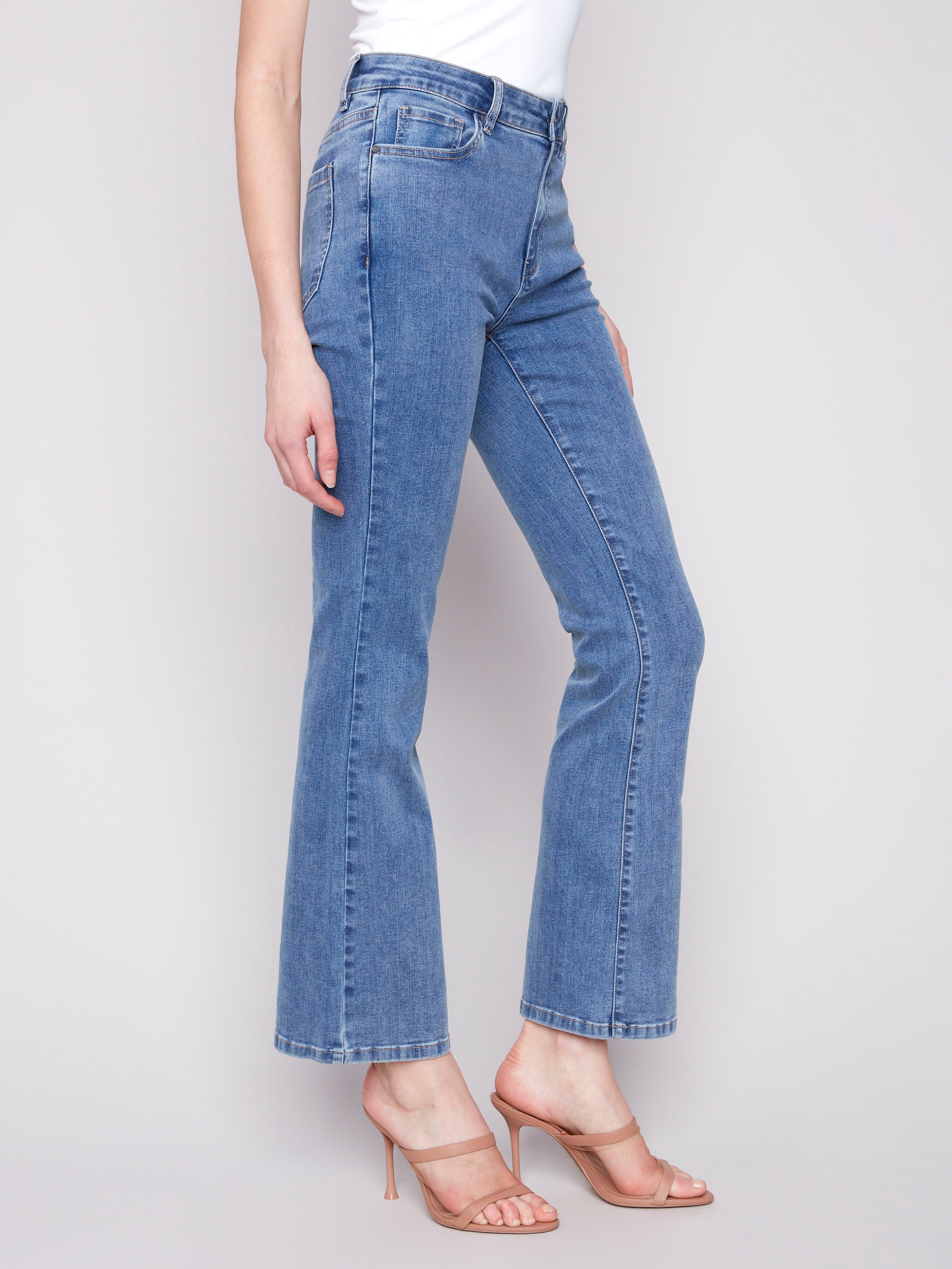 Medium blue Celine flare leg jeans with a classic five-pocket design by Charlie B.