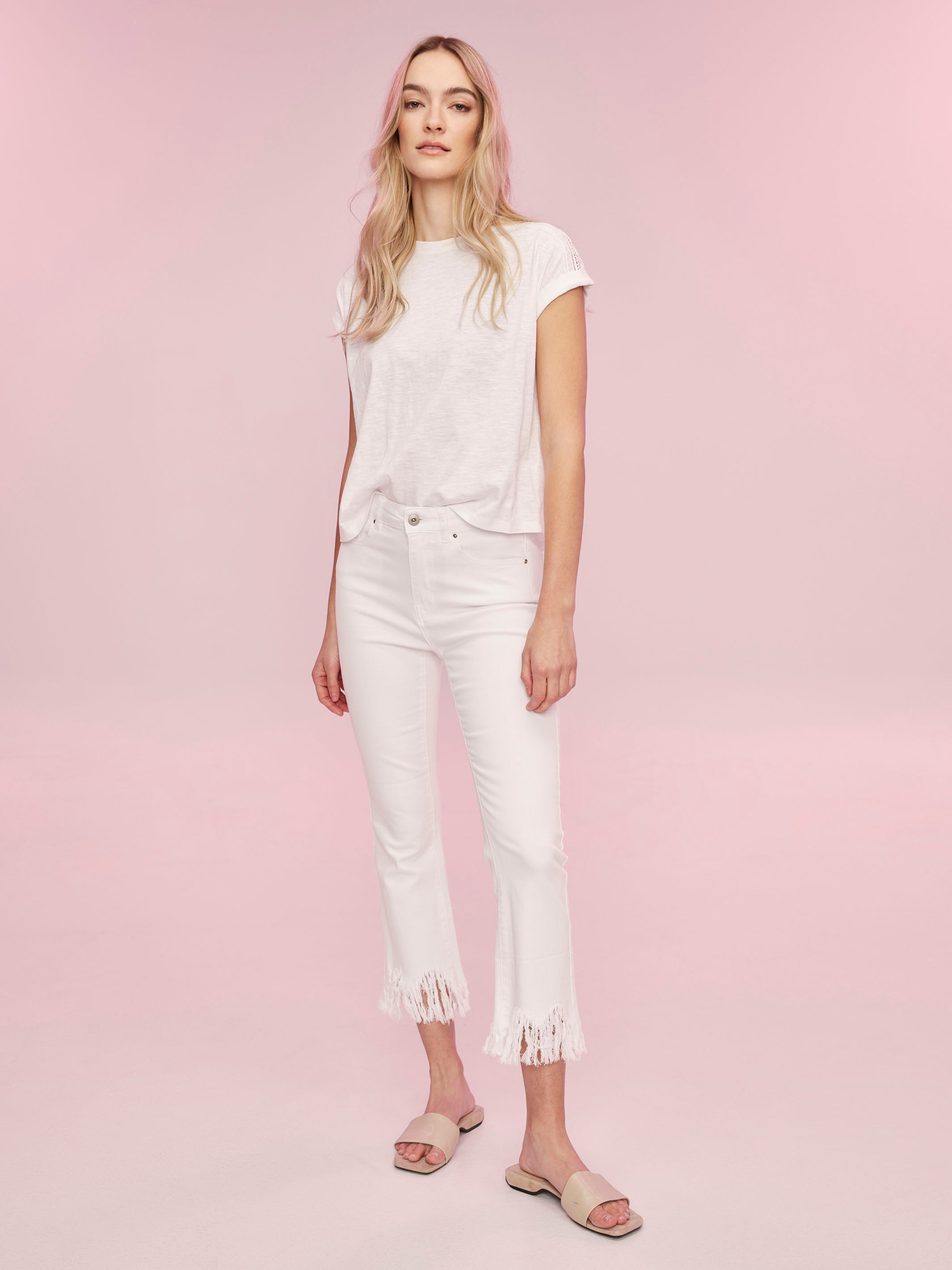 Versatile white T-shirt with delicate lace accents for added flair by Charlie B.