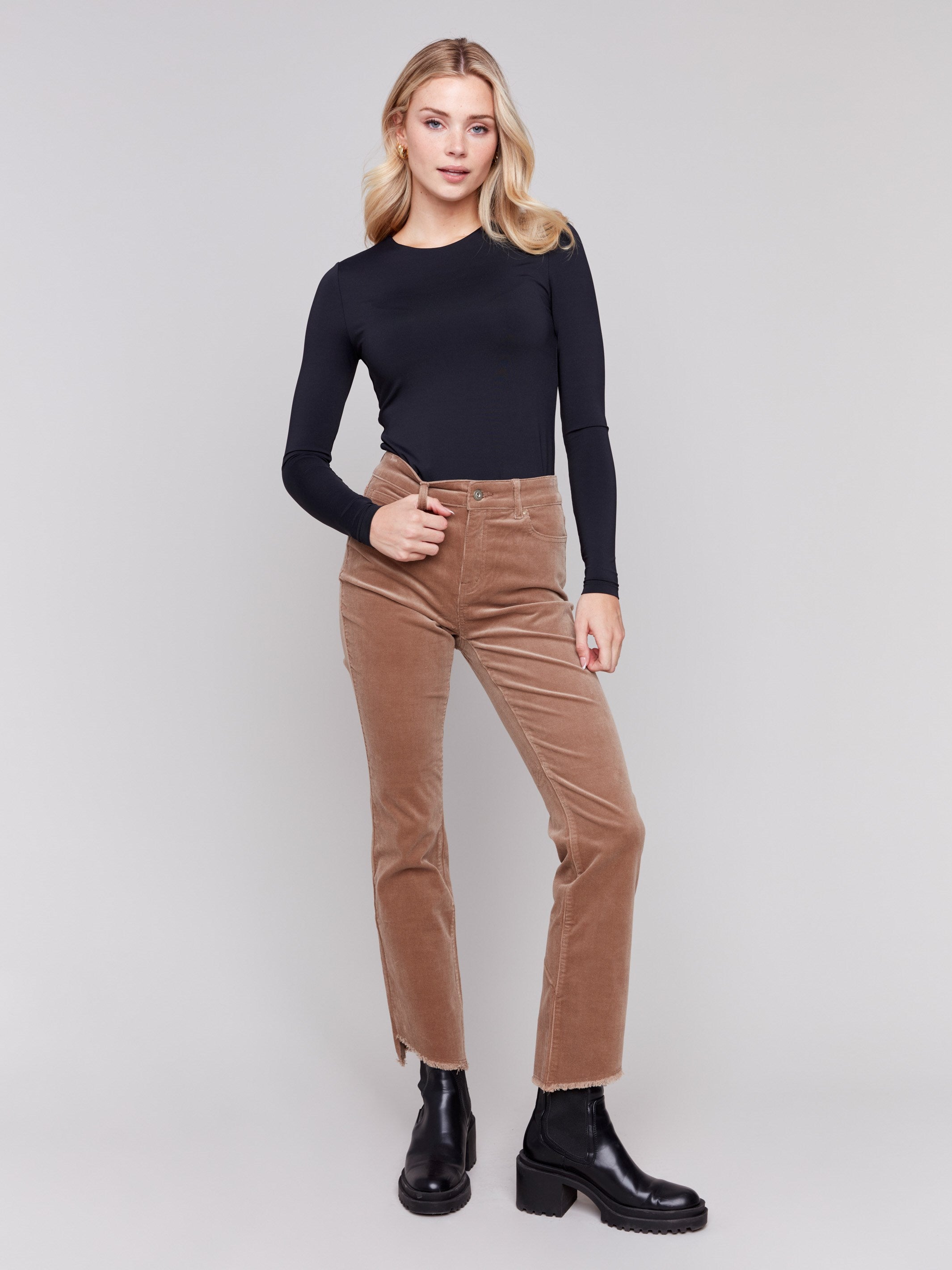 Truffle-colored bootcut corduroy pants with an asymmetrical frayed hem and a bootcut fit by Charlie B.