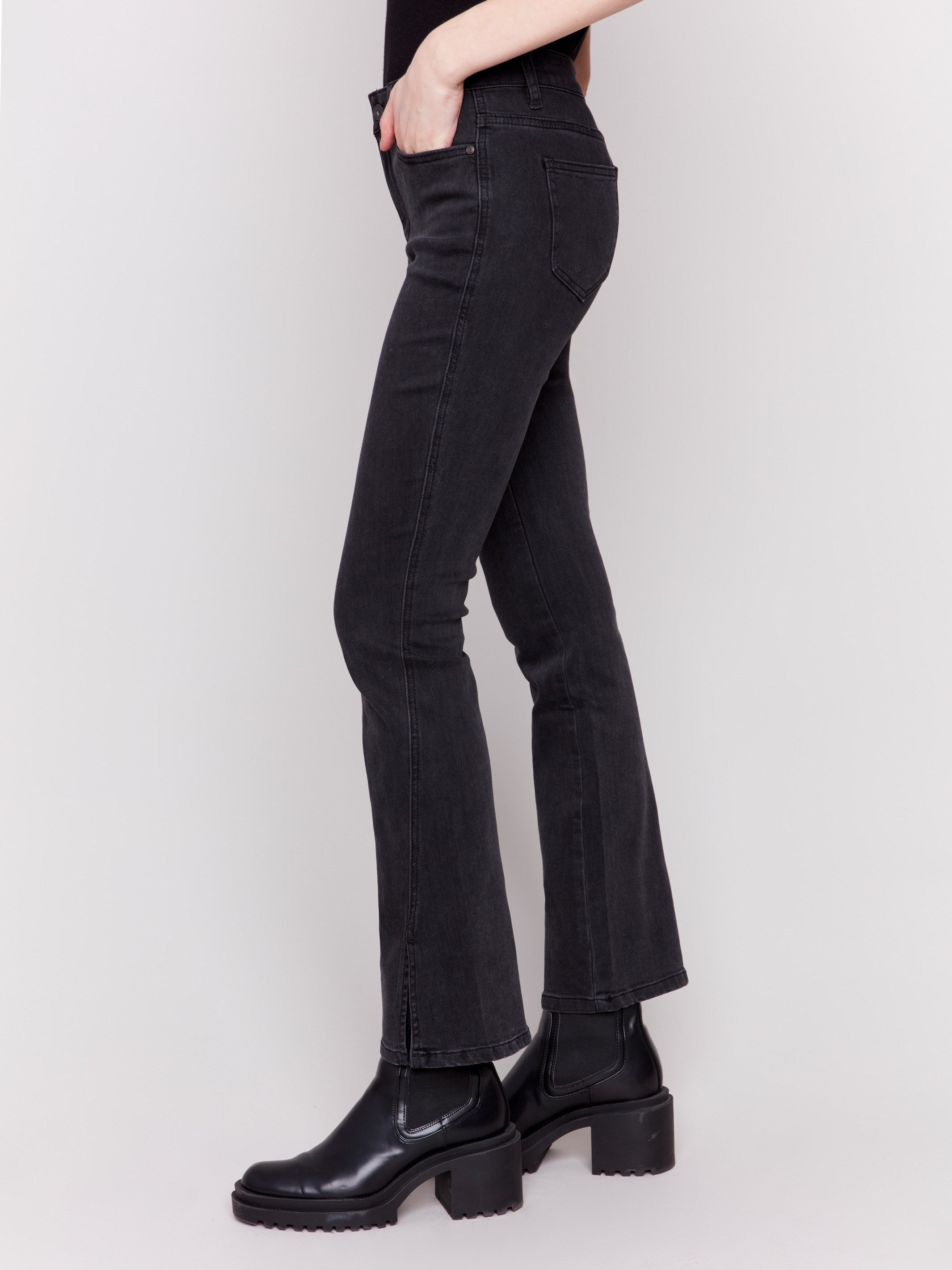 Charcoal black bootcut jeans with front slits, regular rise, and a five-pocket design by Charlie B.