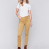 Amber yellow bootcut twill pants with an asymmetrical fringe hem and mid-rise waist by Charlie B.