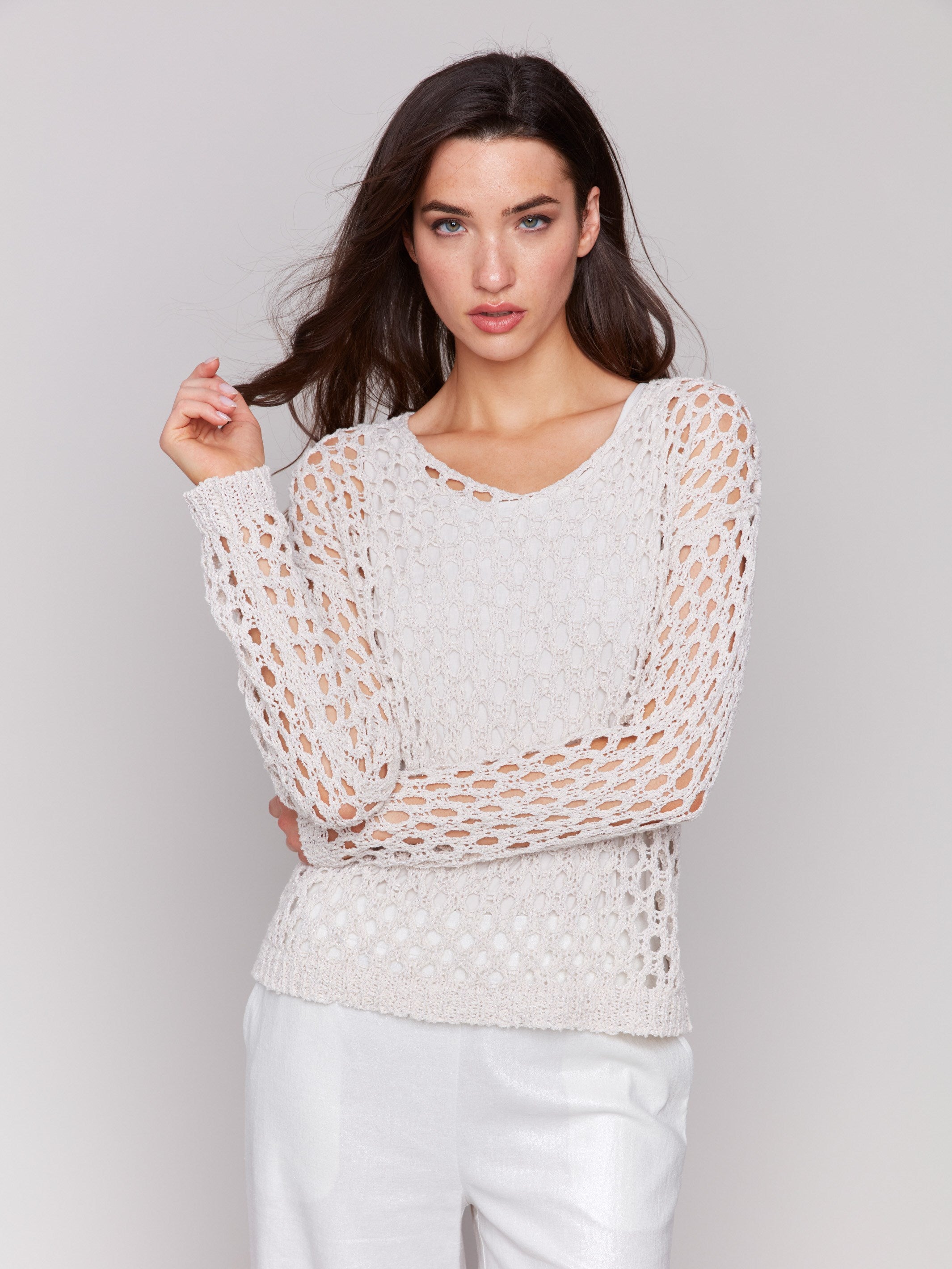 Petal-colored sweater with a braided fishnet design by Charlie B.