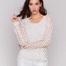 Petal-colored sweater with a braided fishnet design by Charlie B.