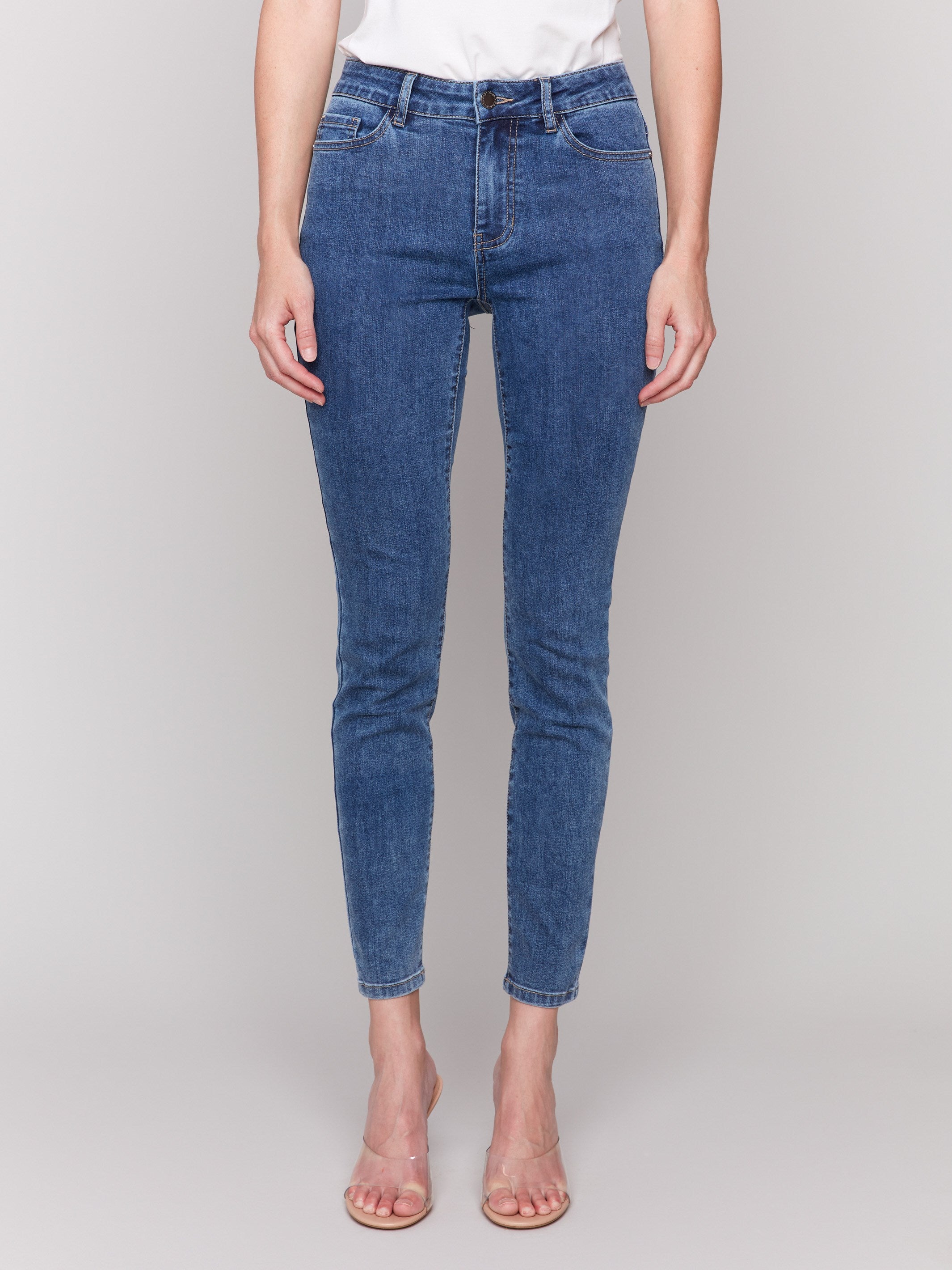 Medium blue skinny jeans featuring a five-pocket design by Charlie B, showcasing a sleek and stylish fit.