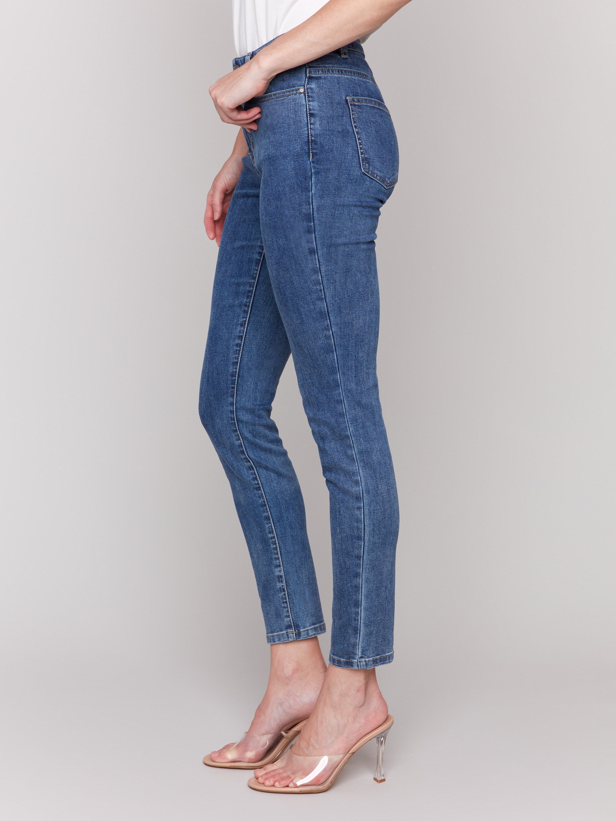 Medium blue skinny jeans featuring a five-pocket design by Charlie B, showcasing a sleek and stylish fit.