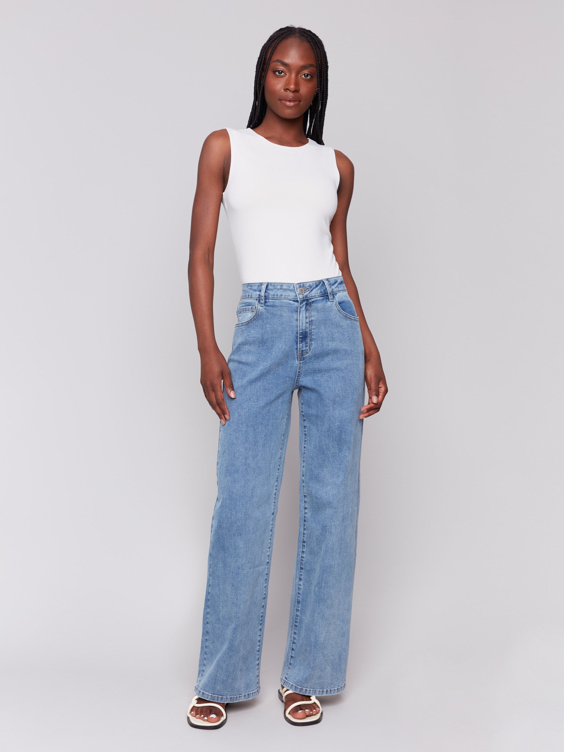 Light blue wide-leg jeans with five-pocket design featuring a button closure and relaxed fit by Charlie B.