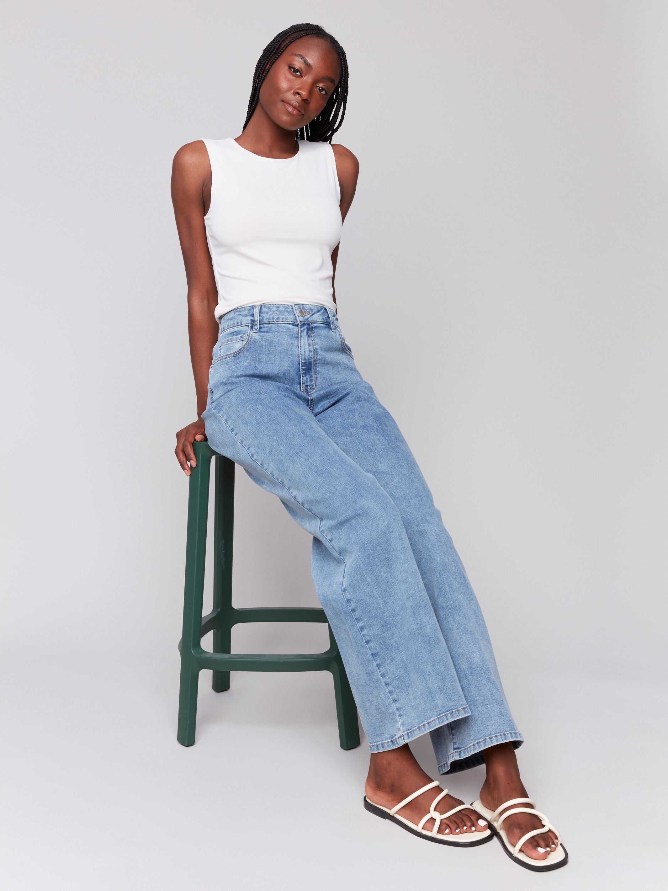 Light blue wide-leg jeans with five-pocket design featuring a button closure and relaxed fit by Charlie B.