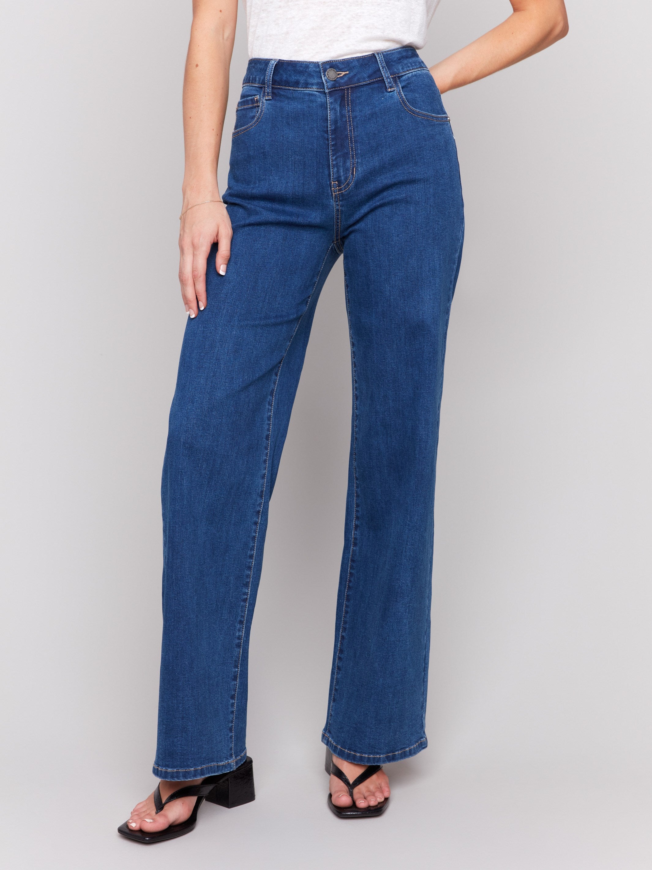 Indigo wide-leg jeans with five-pocket design featuring a button closure and relaxed fit by Charlie B.