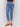 Medium blue slim leg jeans with five-pocket design and button closure by Charlie B.