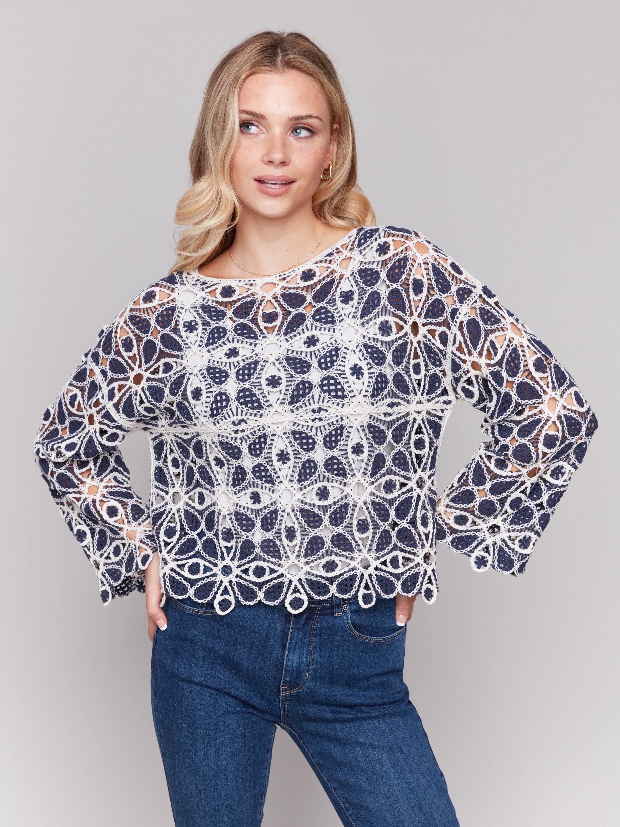 Intricate geometric crochet pattern on a stylish top, perfect for any occasion by Charlie B.