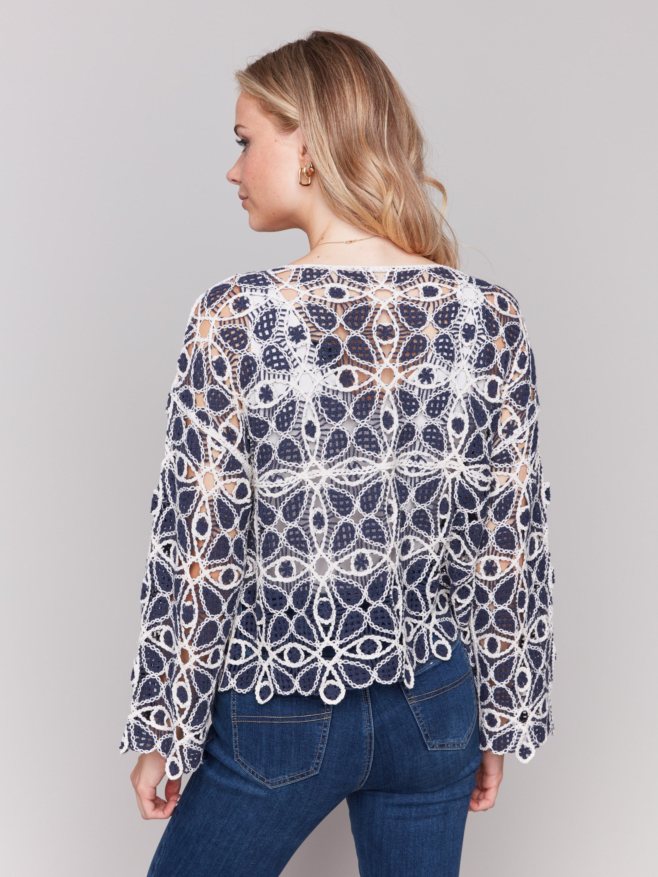 Chic 3/4 sleeve design in a geometric crochet pattern by Charlie B.