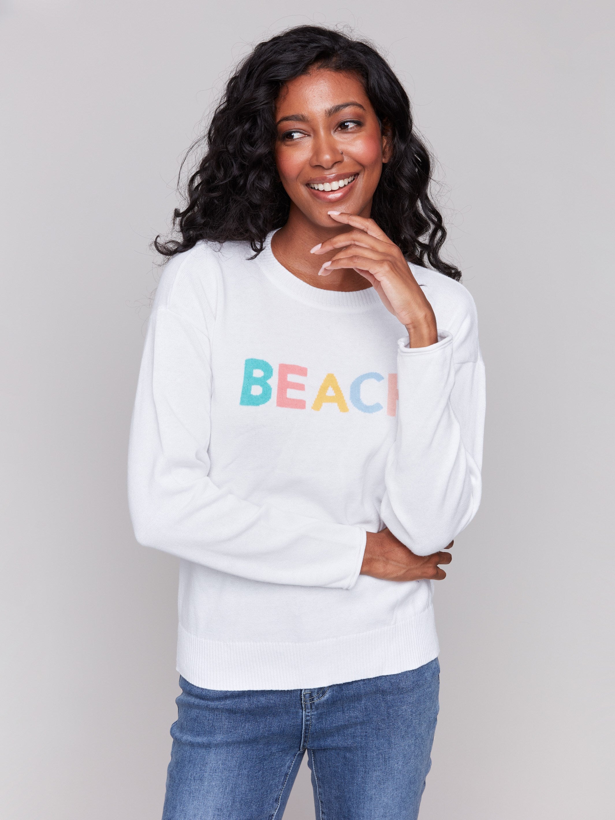 Cozy white cotton sweater adorned with cheerful graphics by Charlie B.