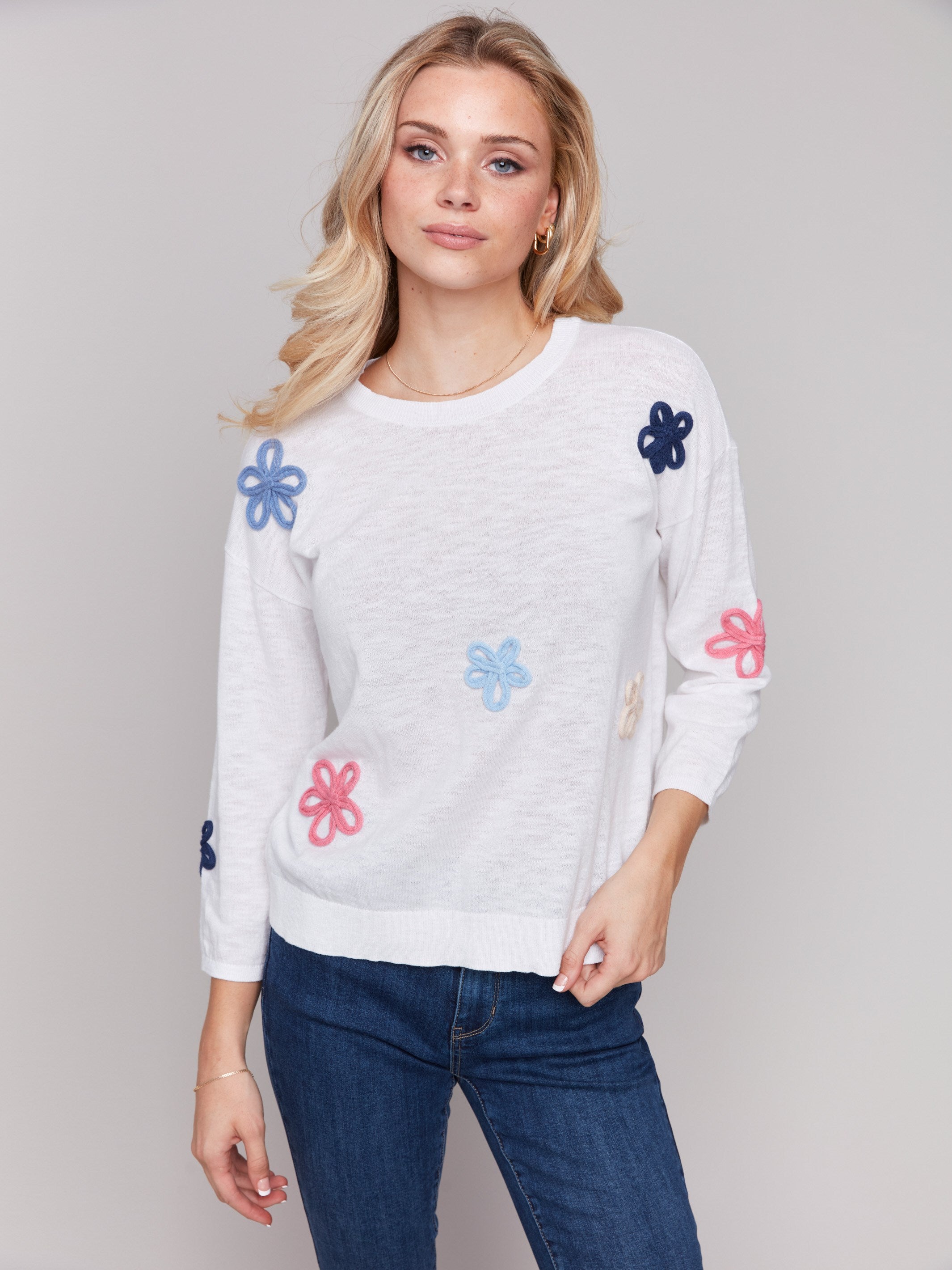 Round neckline sweater with intricate flower patches by Charlie B.