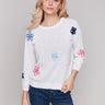 Round neckline sweater with intricate flower patches by Charlie B.