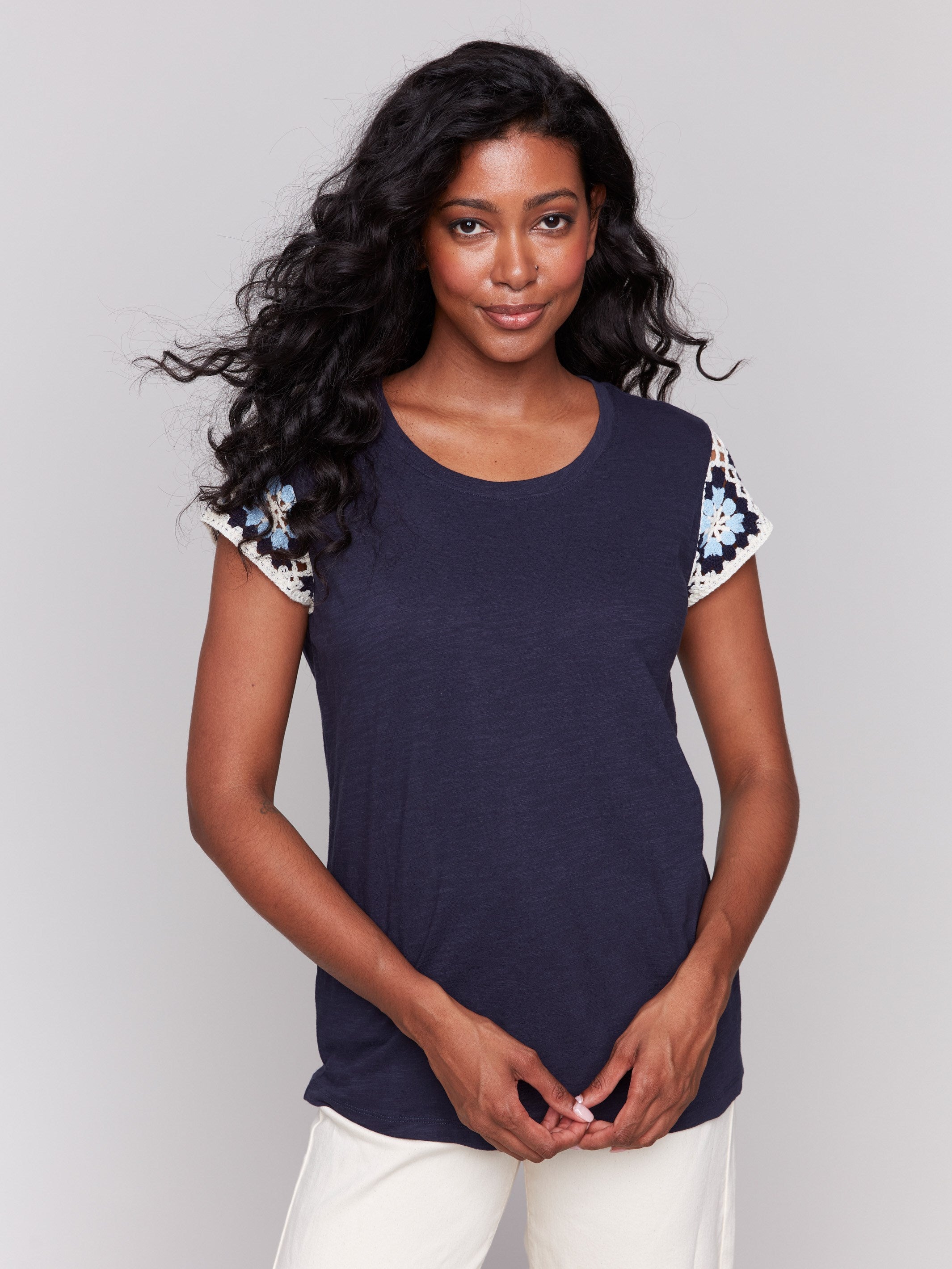 Navy t-shirt featuring crochet cap sleeves, made from 100% cotton by Charlie B.