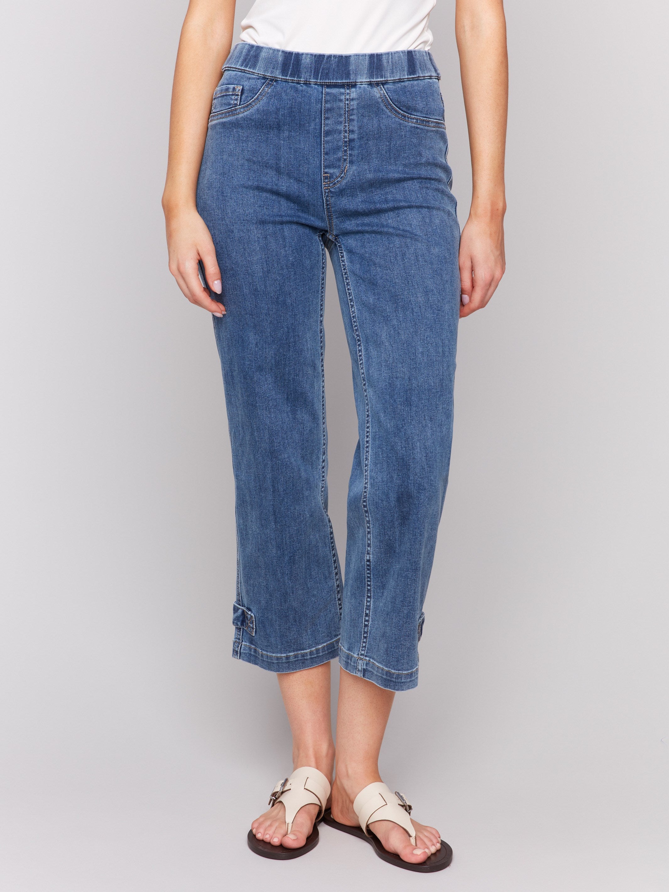 Medium blue jeans featuring two faux front pockets and two back pockets by Charlie B.