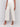 Beige cropped wide-leg pants with a side zipper, styled with a white top and beige heels by Charlie B.