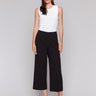 Black cropped wide-leg pants with a side zipper, worn by a model in a white top, by Charlie B.