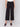 Black cropped wide-leg pants with a side zipper, worn by a model in a white top, by Charlie B.