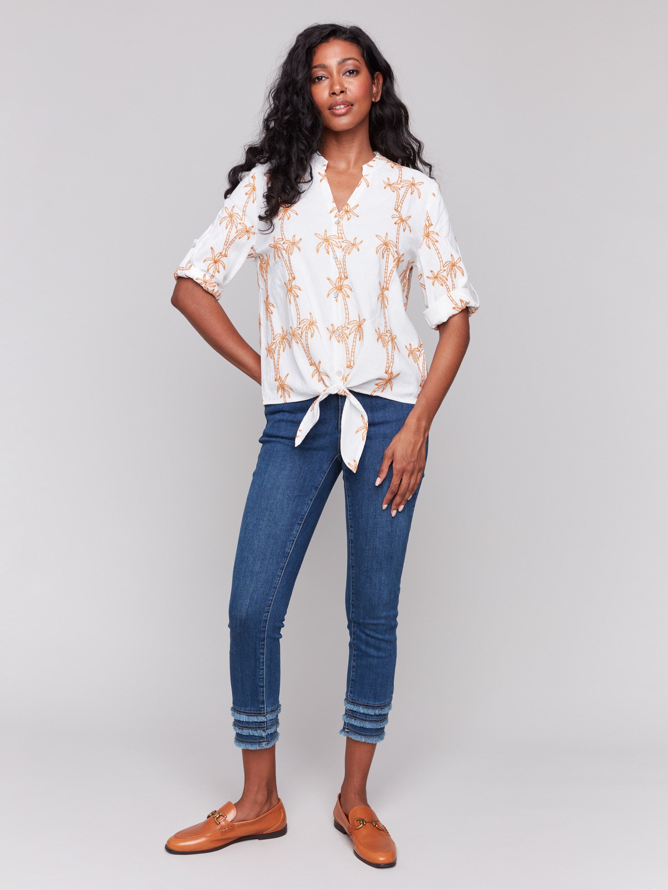 Chic blouse featuring a button-down front in papaya by Charlie B.