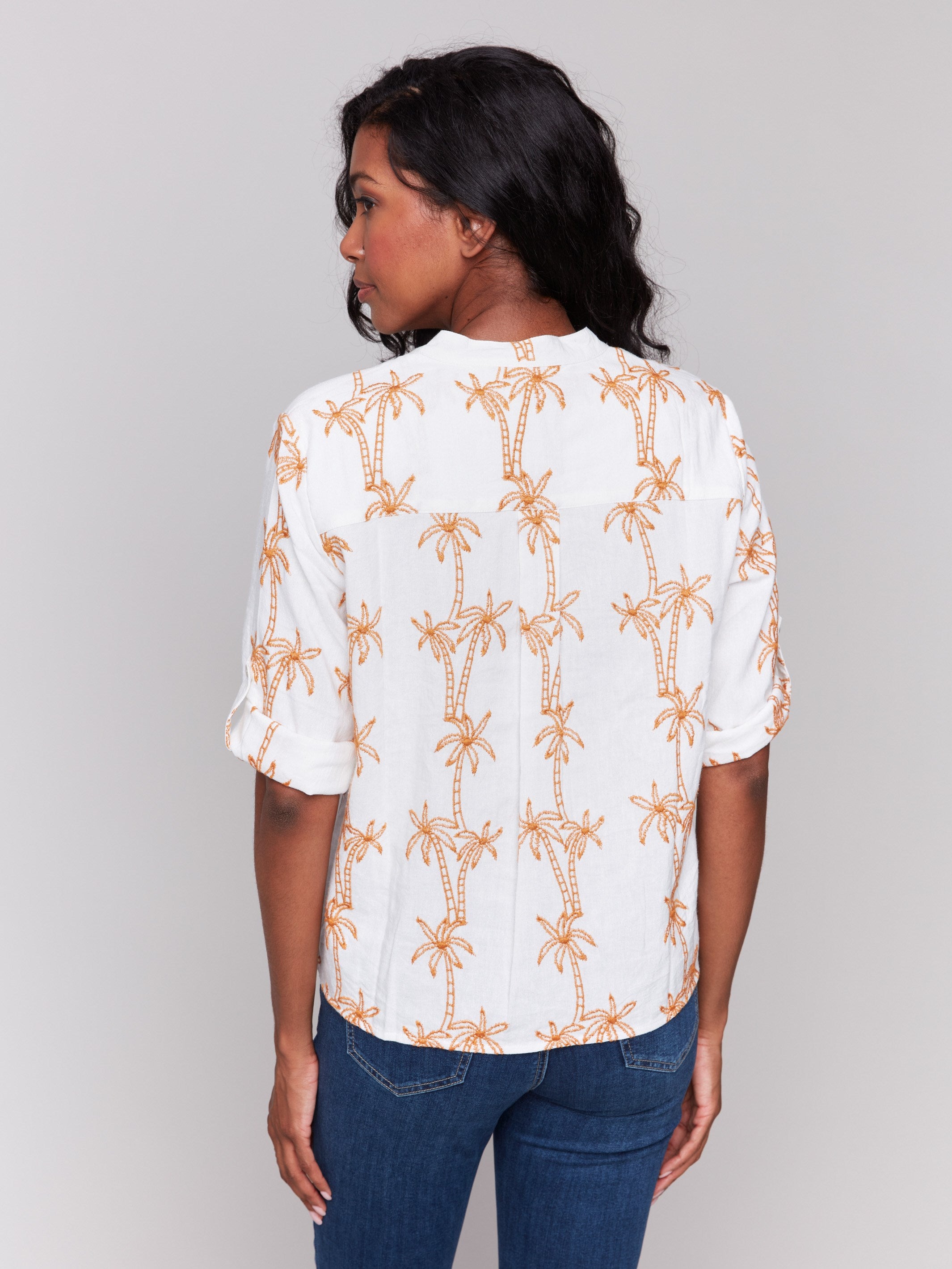 Blouse with intricate palm tree embroidery in vibrant papaya by Charlie B.