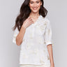 Blouse with intricate gold embroidery and half-button front by Charlie B.