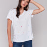 White V-neck t-shirt with colorful heart embroidery, featuring short sleeves by Charlie B.