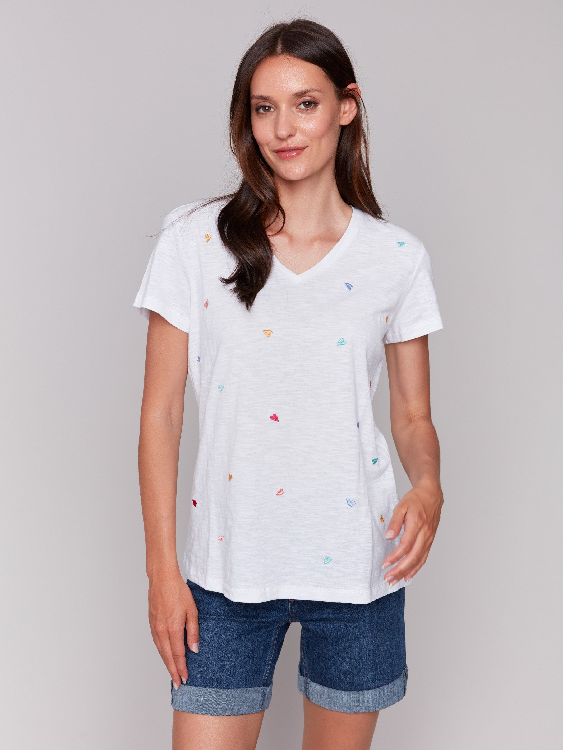 White V-neck t-shirt with colorful heart embroidery, featuring short sleeves by Charlie B.