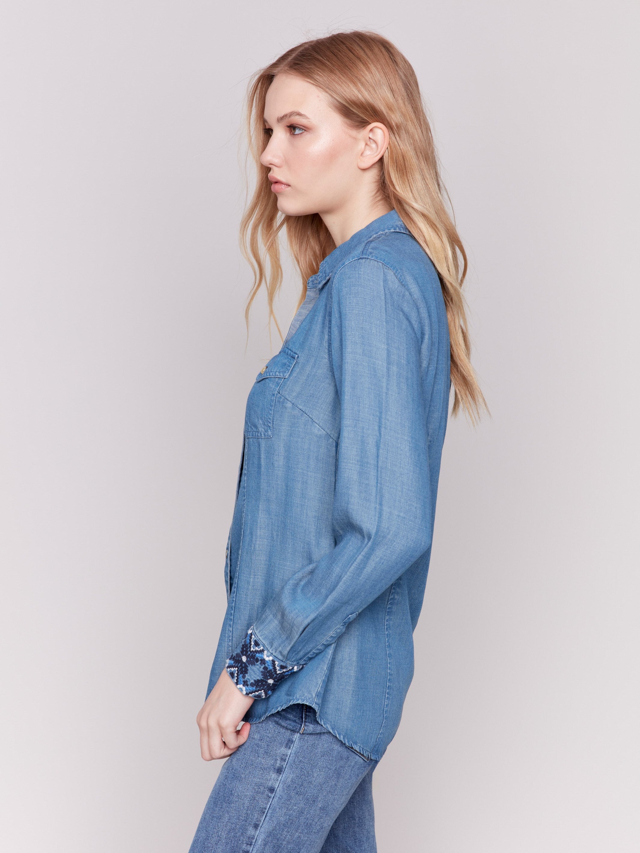 Denim-colored long sleeve Tencel shirt featuring embroidered cuffs and front button closure by Charlie B.