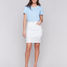 White denim skort featuring slim fit design by Charlie B.