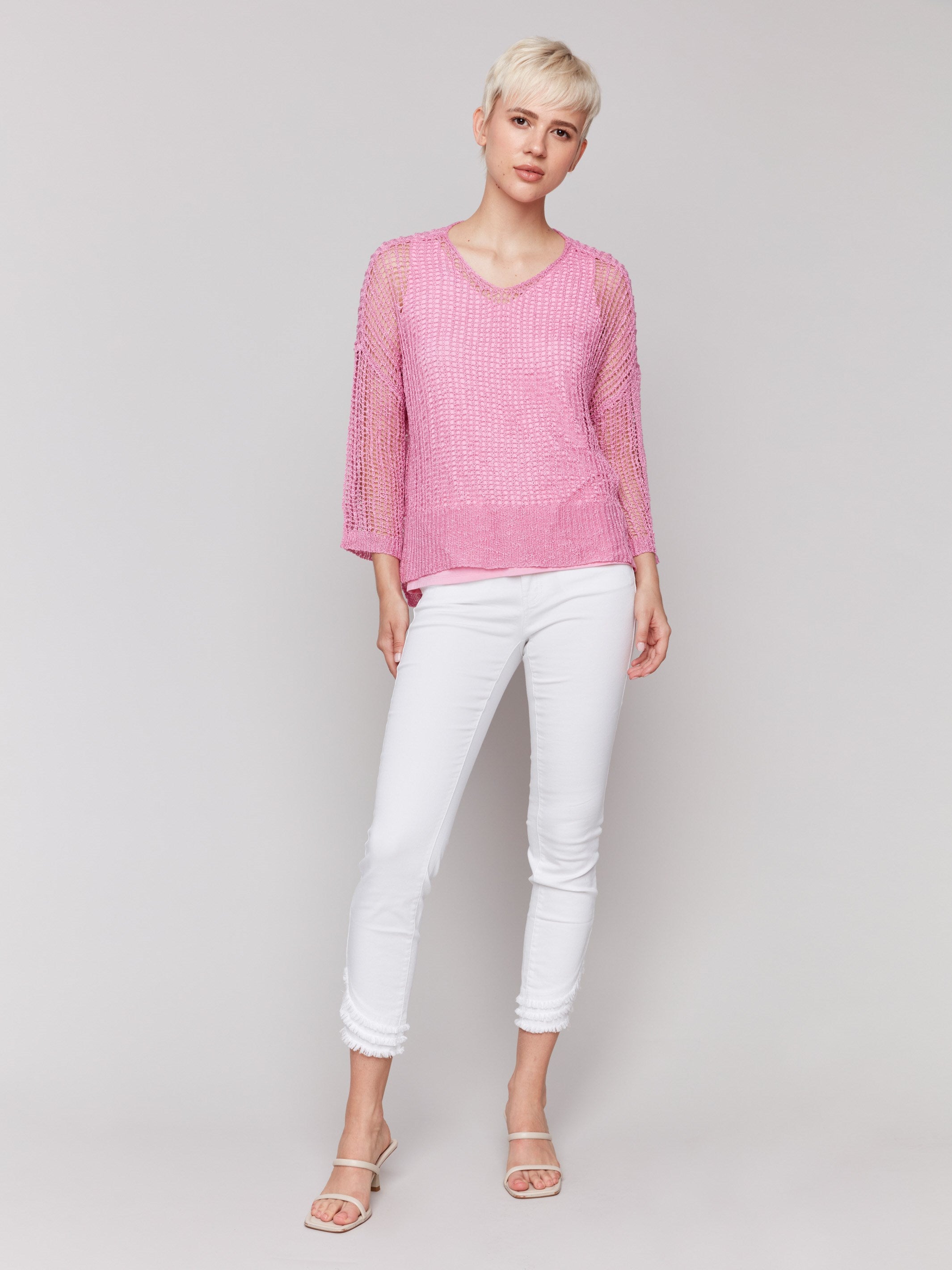 Pink crochet sweater showcasing a comfortable loose fit by Charlie B.