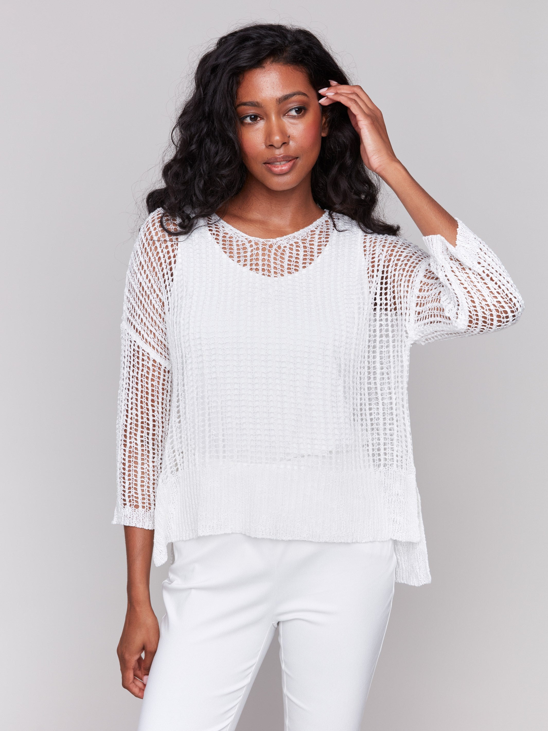 White fishnet crochet sweater with a loose fit by Charlie B.