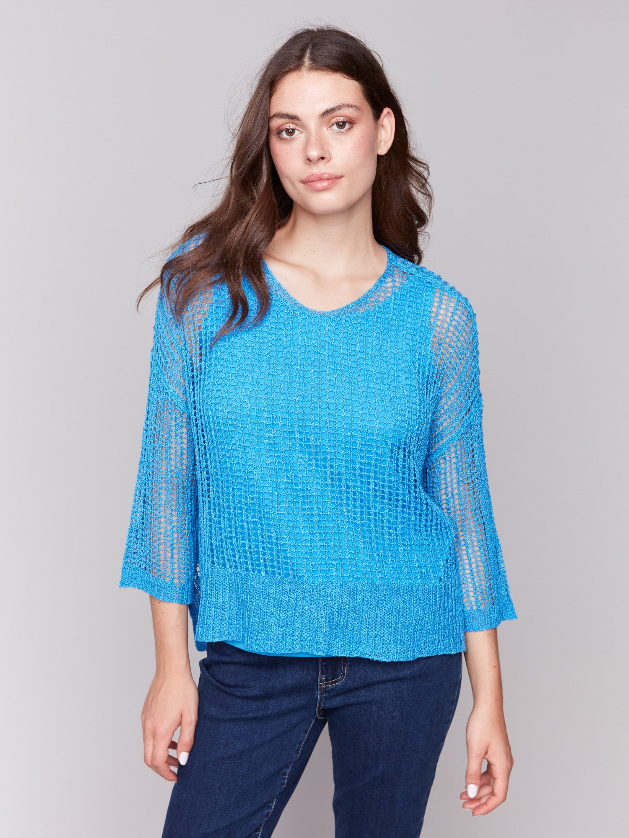 Lagoon blue fishnet crochet sweater with a relaxed V-neck by Charlie B.