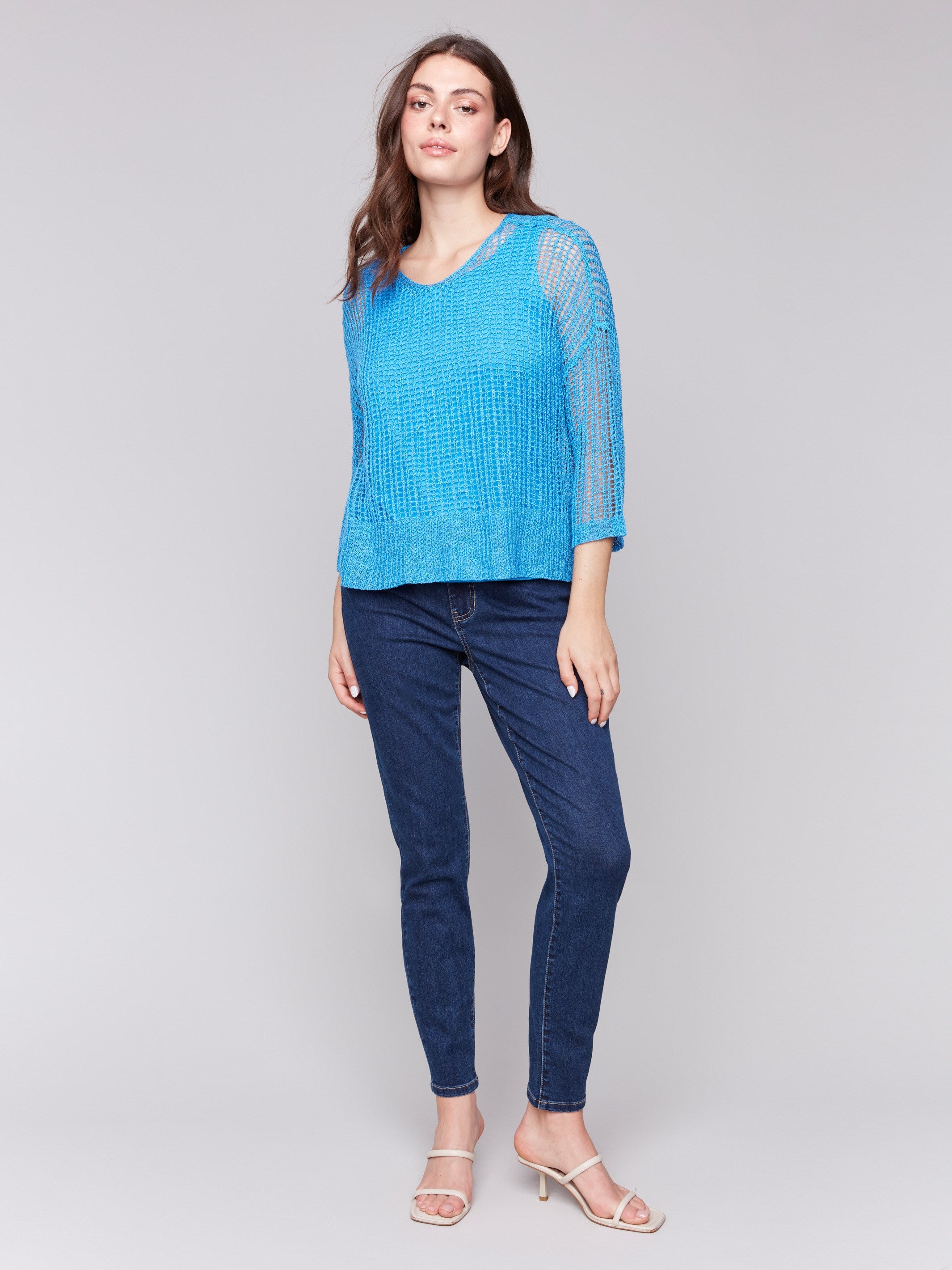 Lagoon blue fishnet crochet sweater featuring drop shoulders by Charlie B.