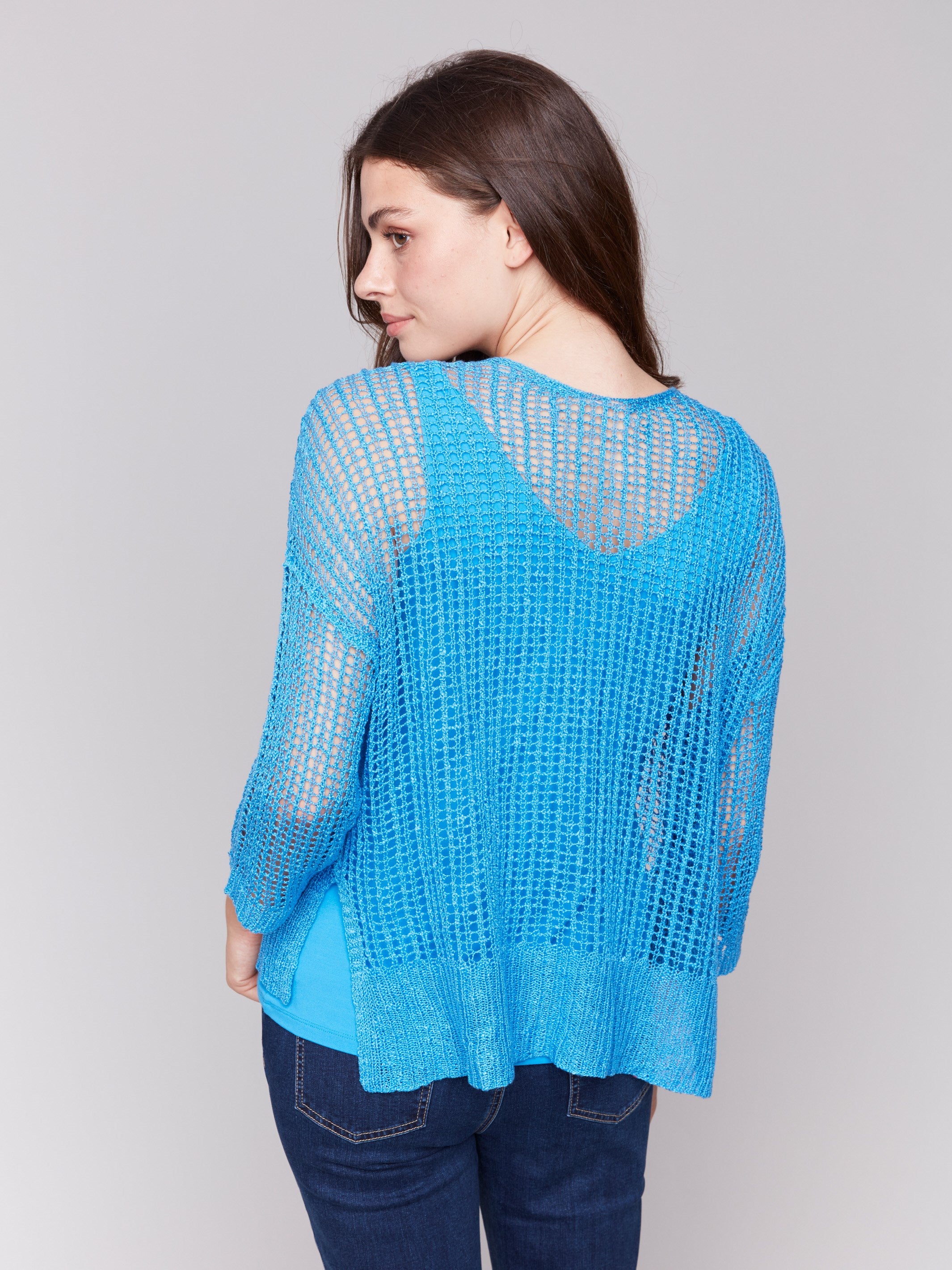 Lagoon blue fishnet crochet sweater with loose fit design by Charlie B.