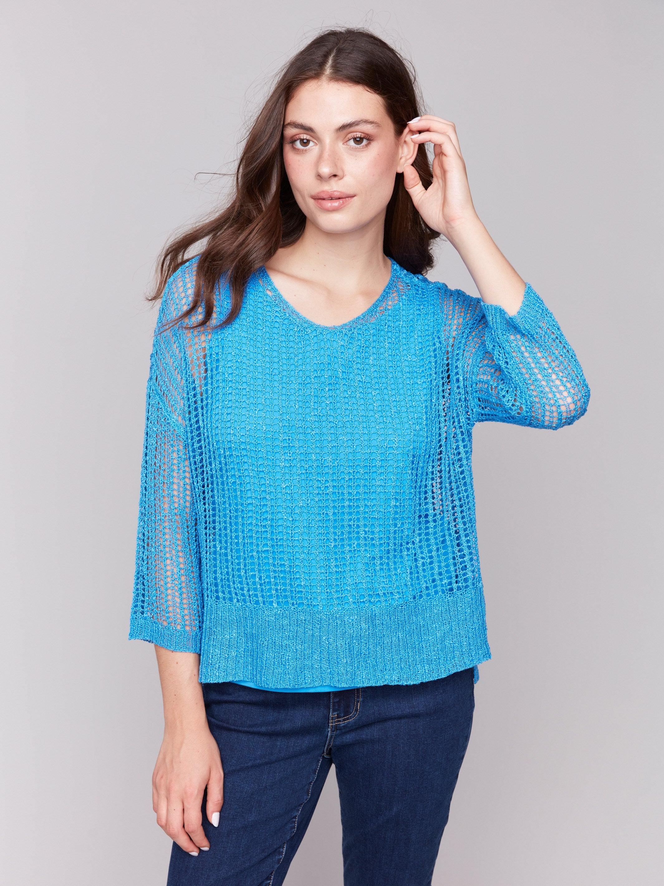 Lagoon blue fishnet crochet sweater styled with 3/4 sleeves by Charlie B.