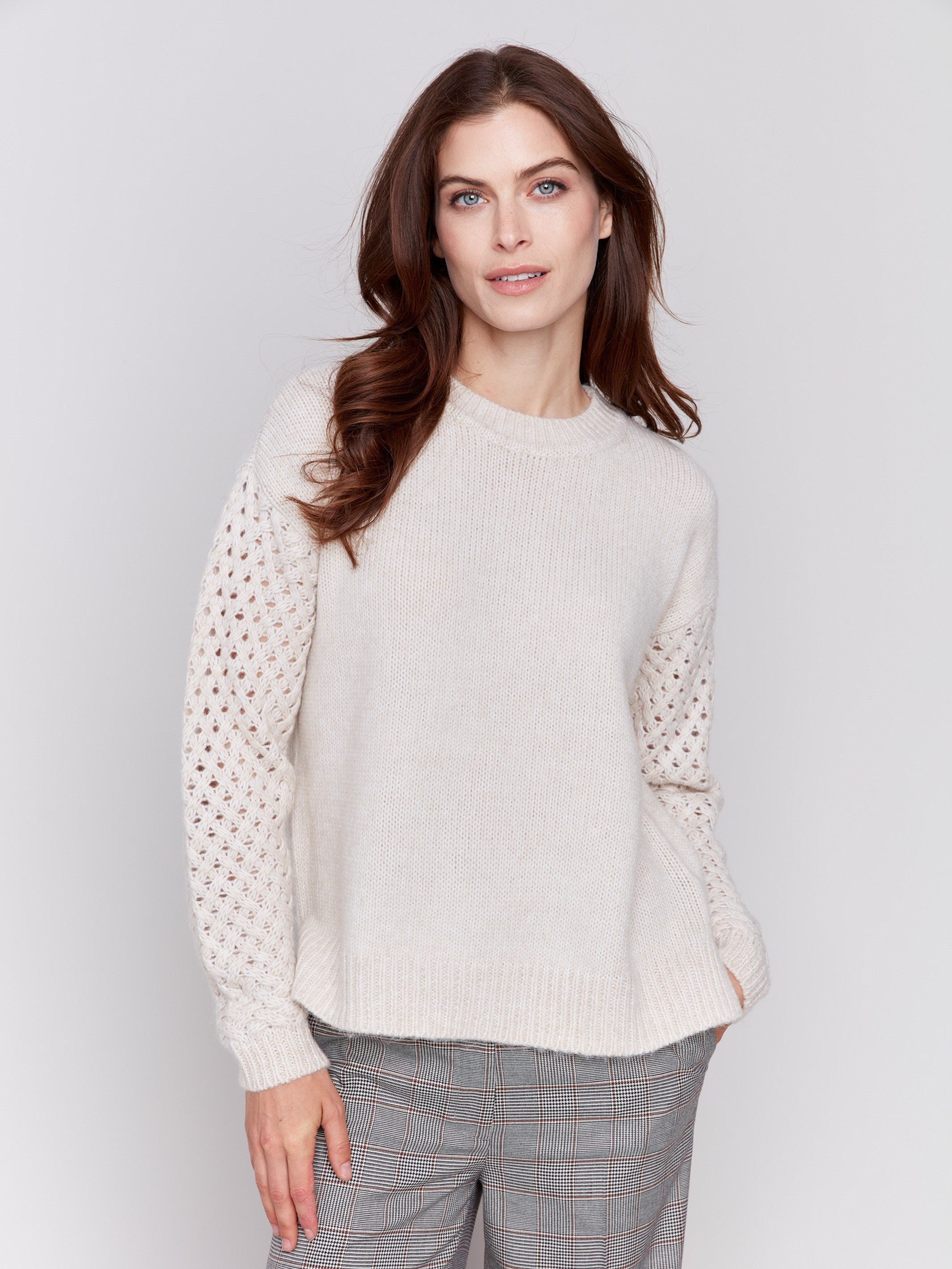 Almond beige crew neck sweater with fishnet sleeves, offering a plushy knit texture, designed by Charlie B.