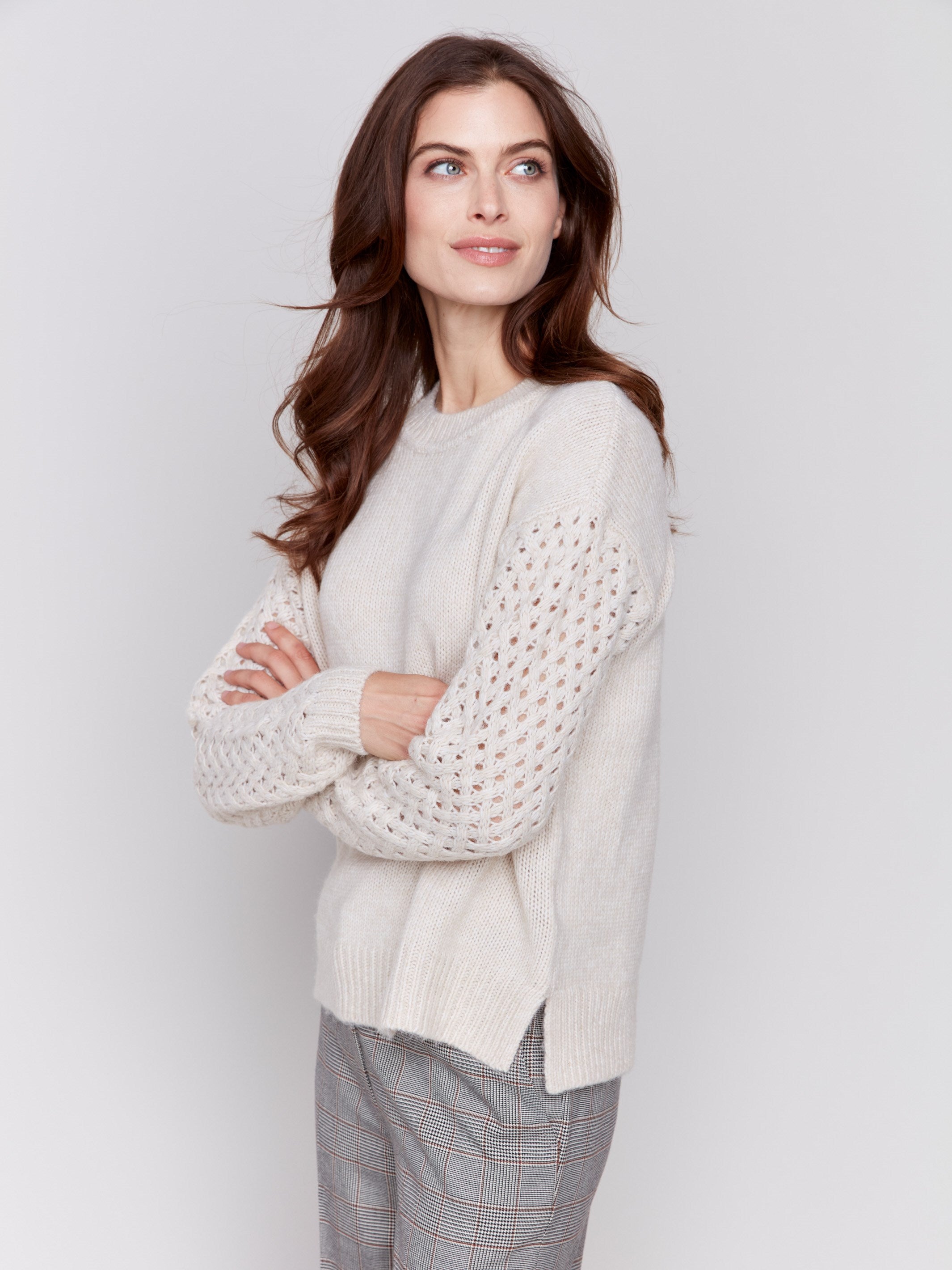 Almond beige crew neck sweater with fishnet sleeves, offering a plushy knit texture, designed by Charlie B.