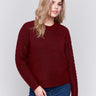 Cabernet red crew neck sweater with fishnet sleeves, offering a plushy knit texture, designed by Charlie B.