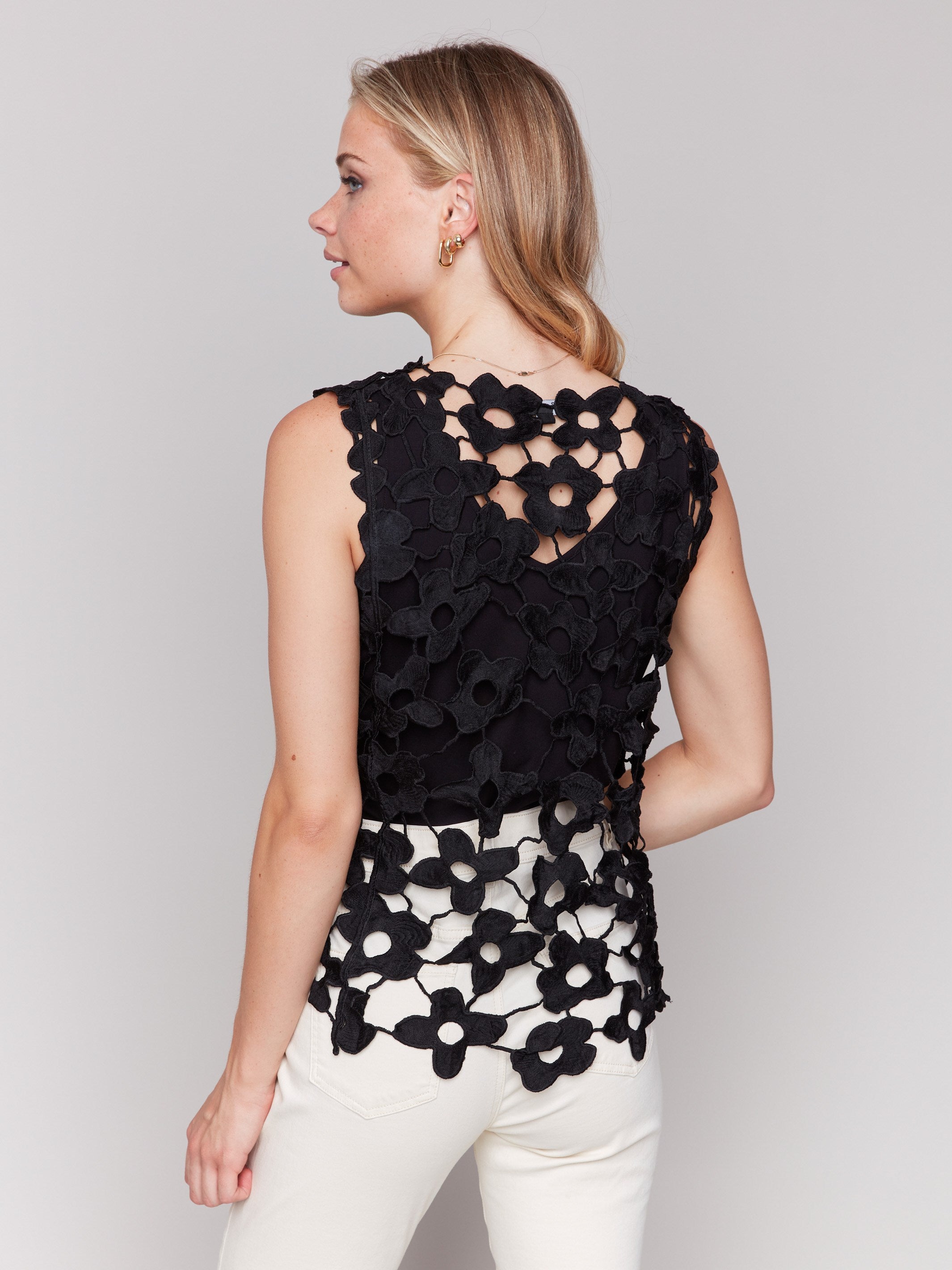 Stylish black sleeveless top showcasing floral patterns by Charlie B.