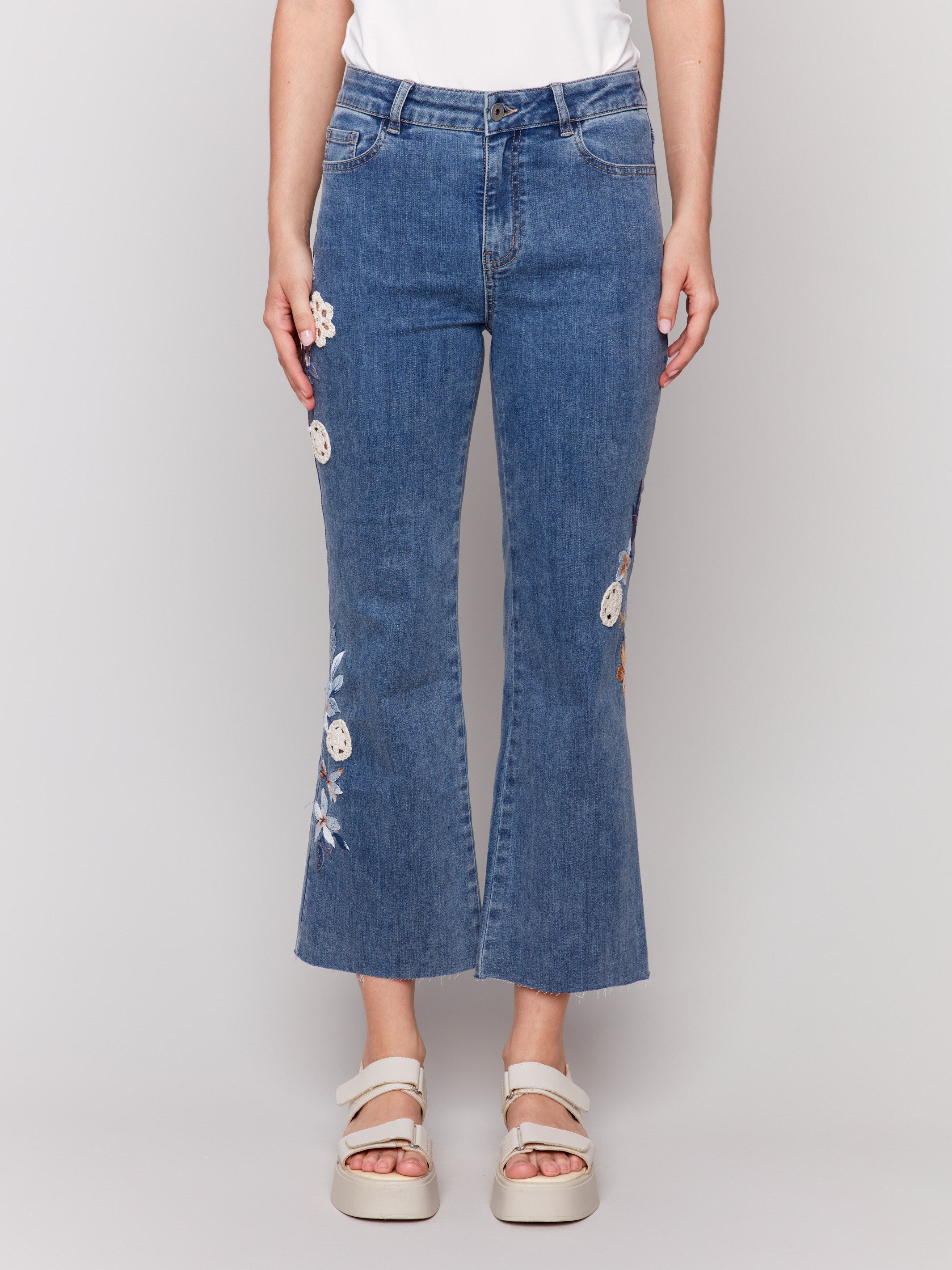 Comfortable stretch denim material in medium blue with floral embroidery by Charlie B.