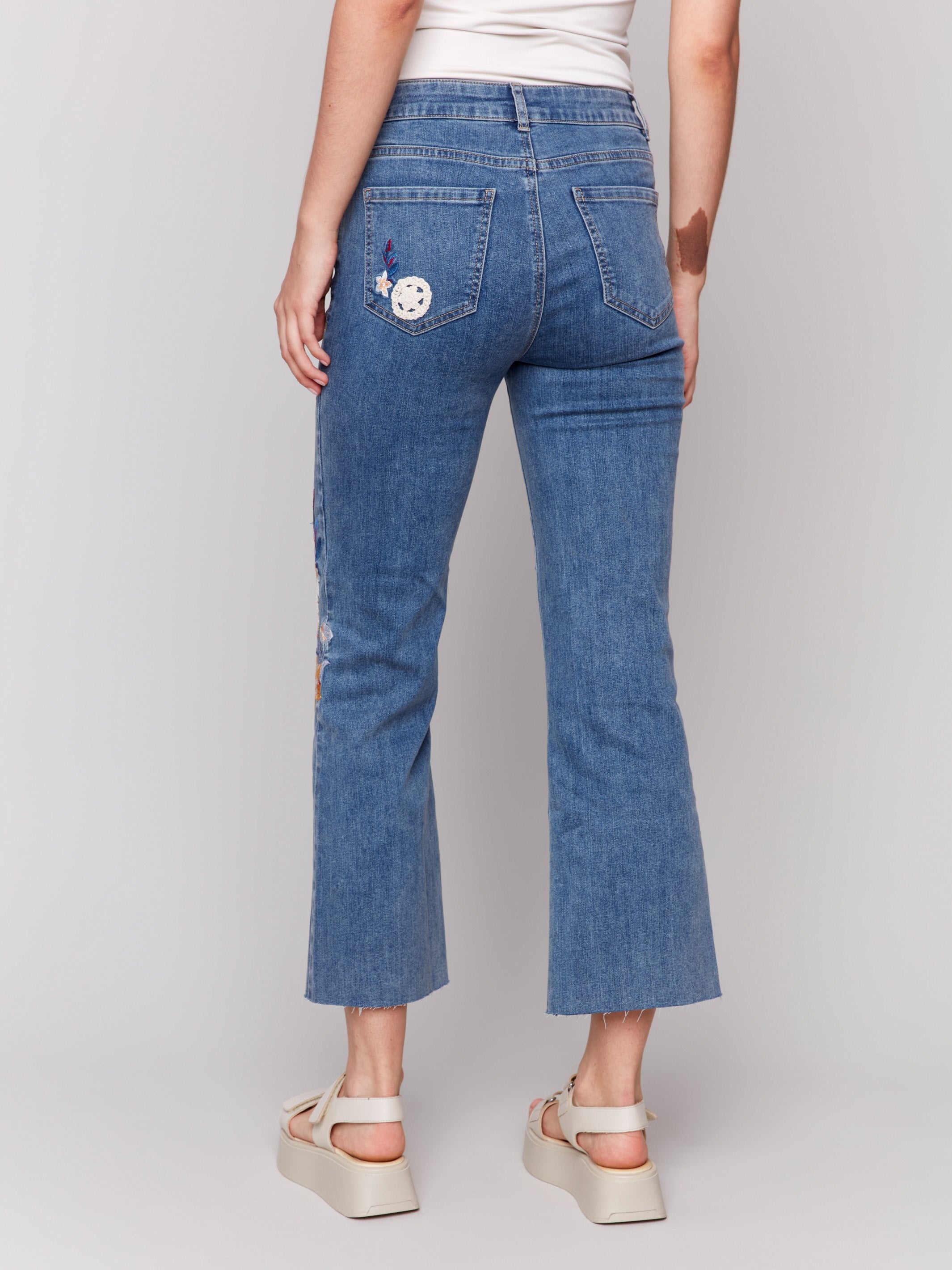 Fashionable medium blue jeans with regular rise and five-pocket design by Charlie B.