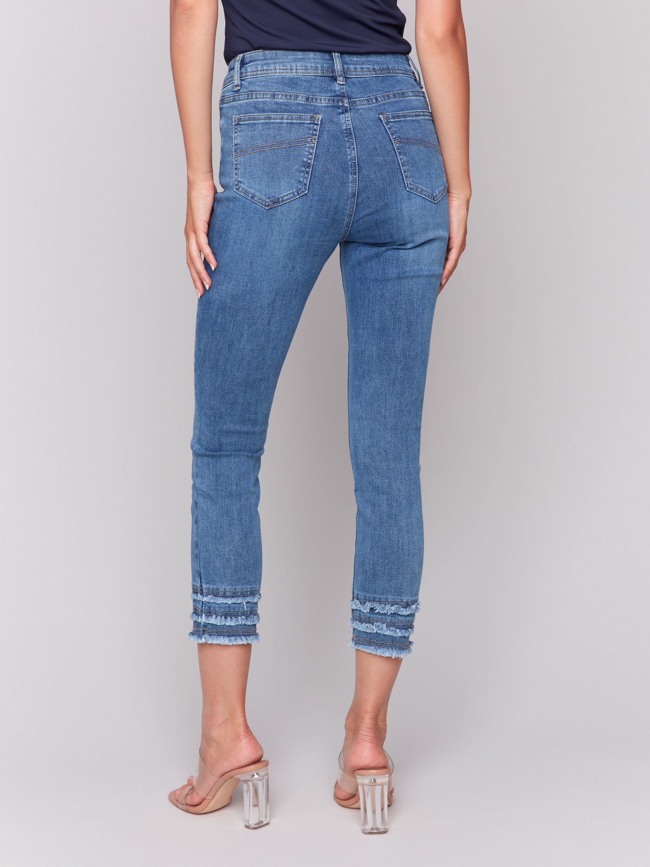 Cropped blue jeans showcasing skinny fit style by Charlie B.